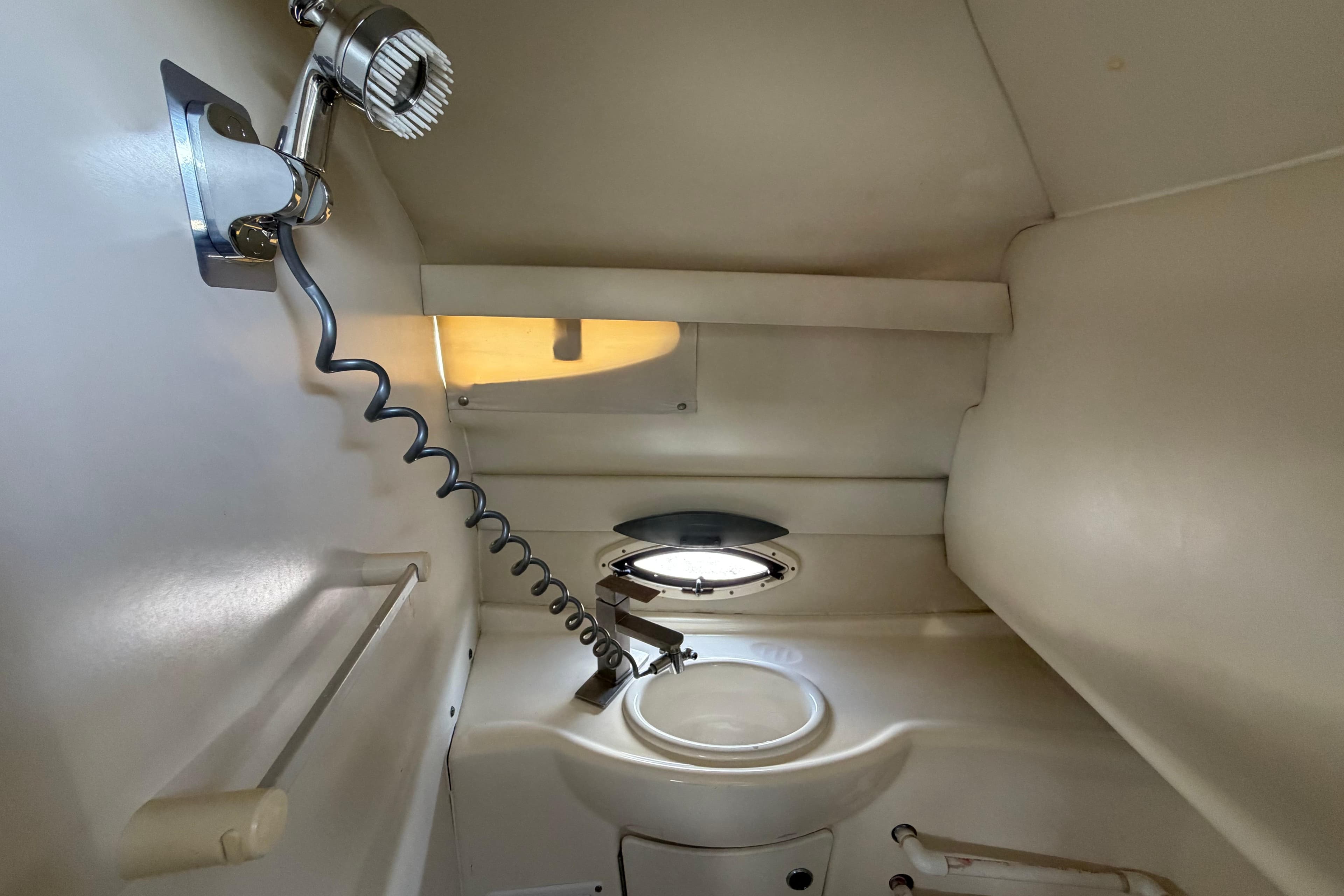 2004 Bayliner 2452 Ciera Express boat bathroom with sink and showerhead.