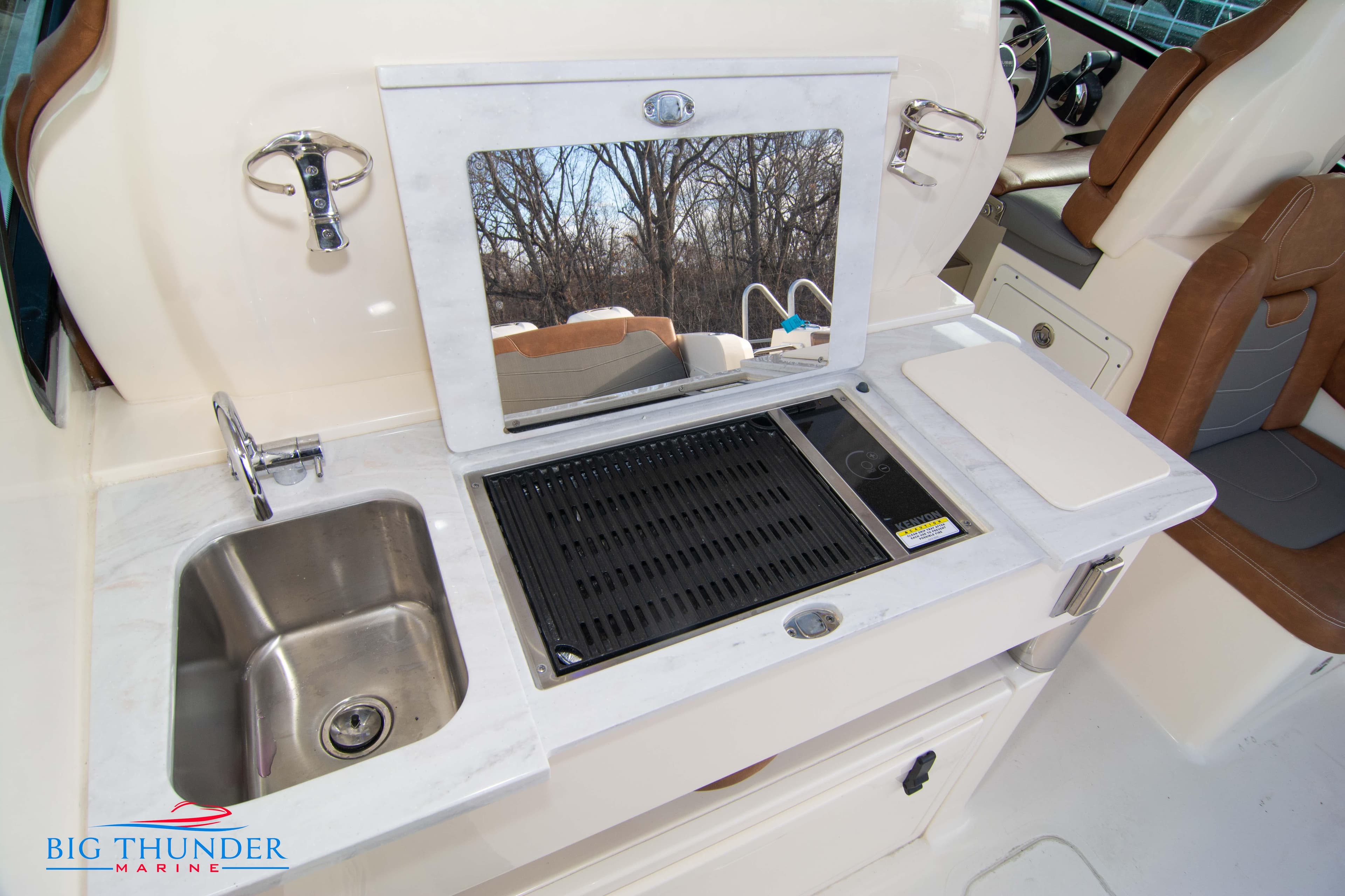 2022 Scout 350 LXZ boat kitchenette with sink, grill, and countertop.