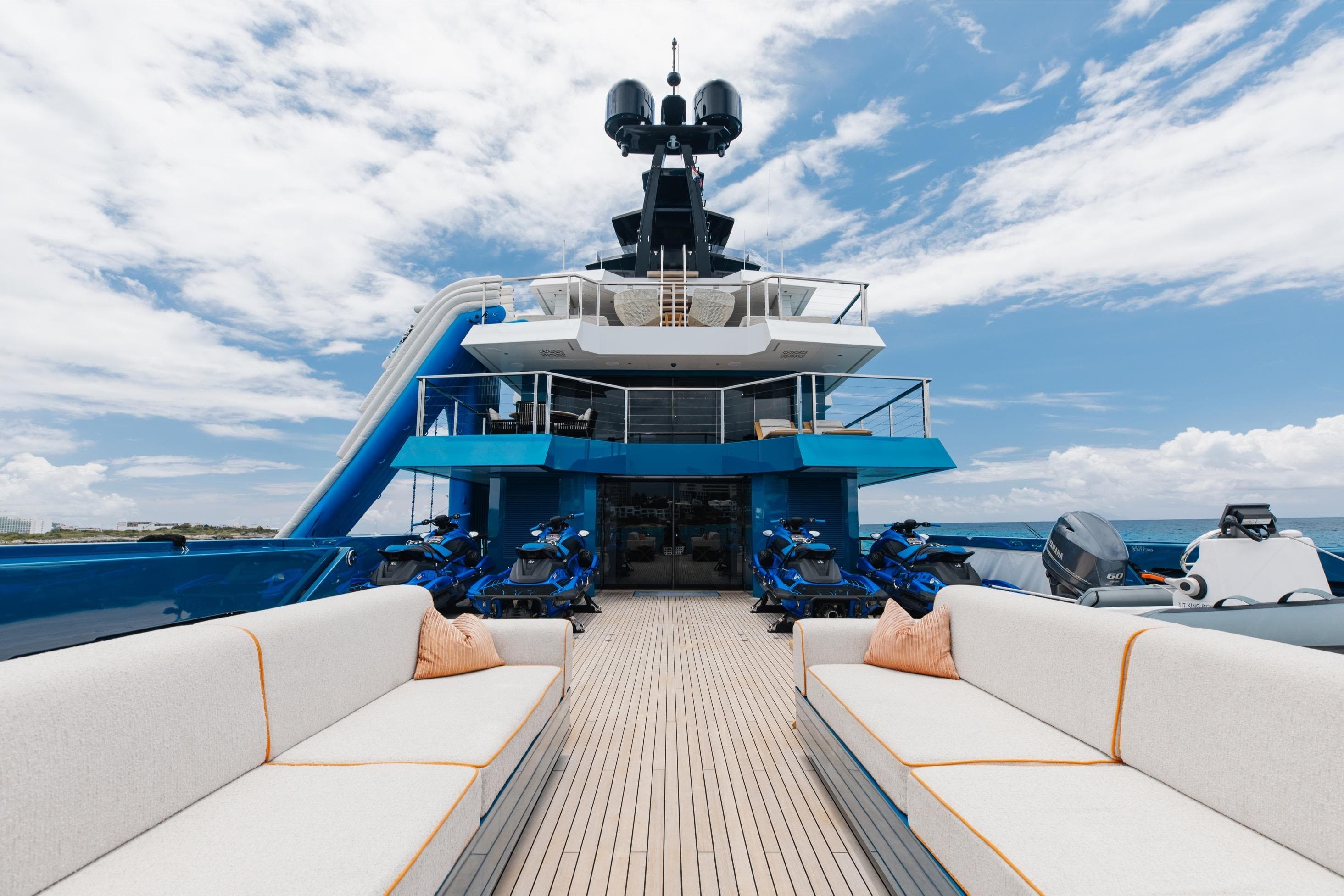 Luxurious 2024 Dunya Yachts Explorer with spacious deck, jet skis, and ocean views.