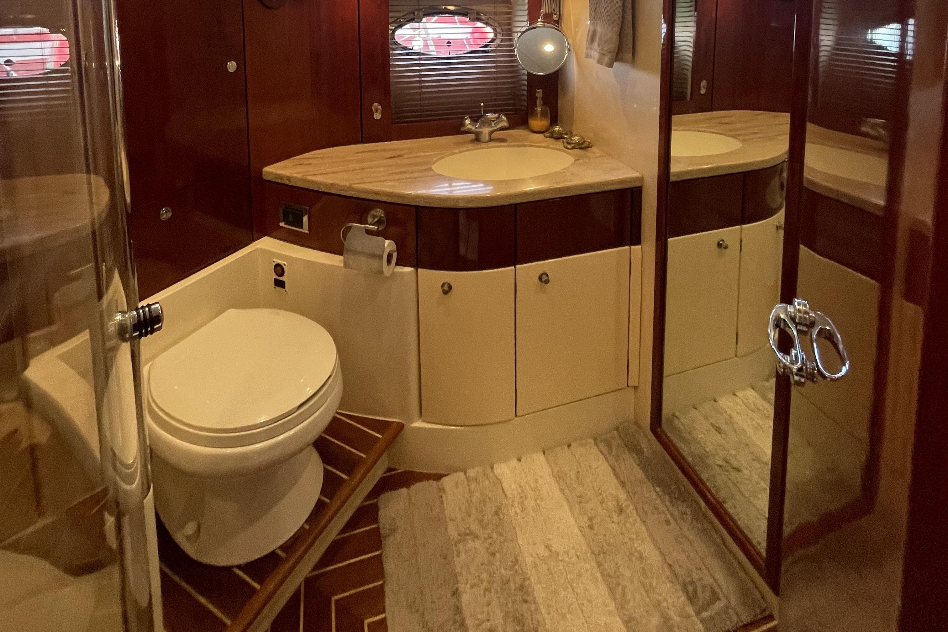 Luxurious bathroom interior of 2001 Fairline Squadron 58 yacht with elegant fixtures.