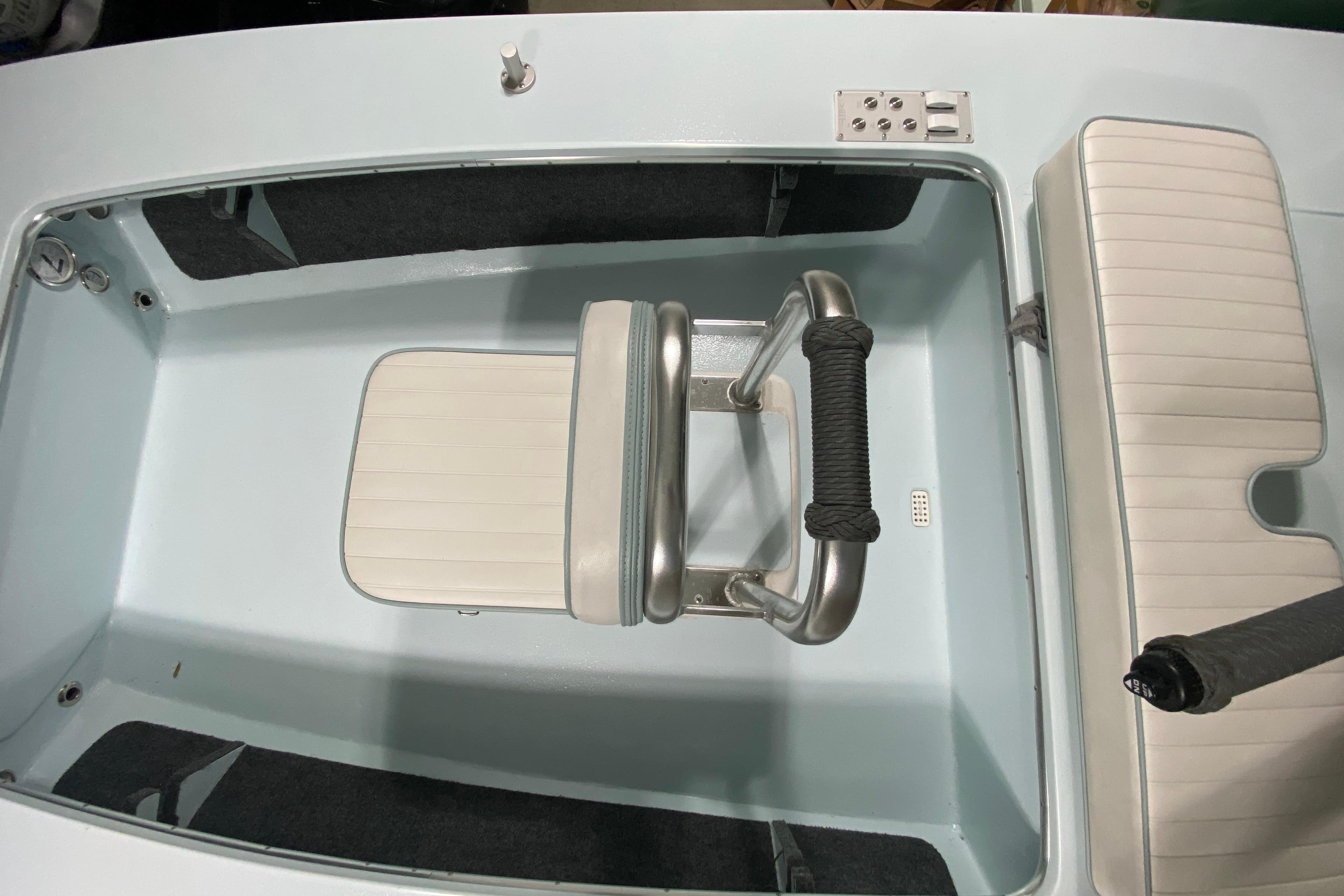 2005 Hell's Bay Devilray boat interior with seating and storage compartments.