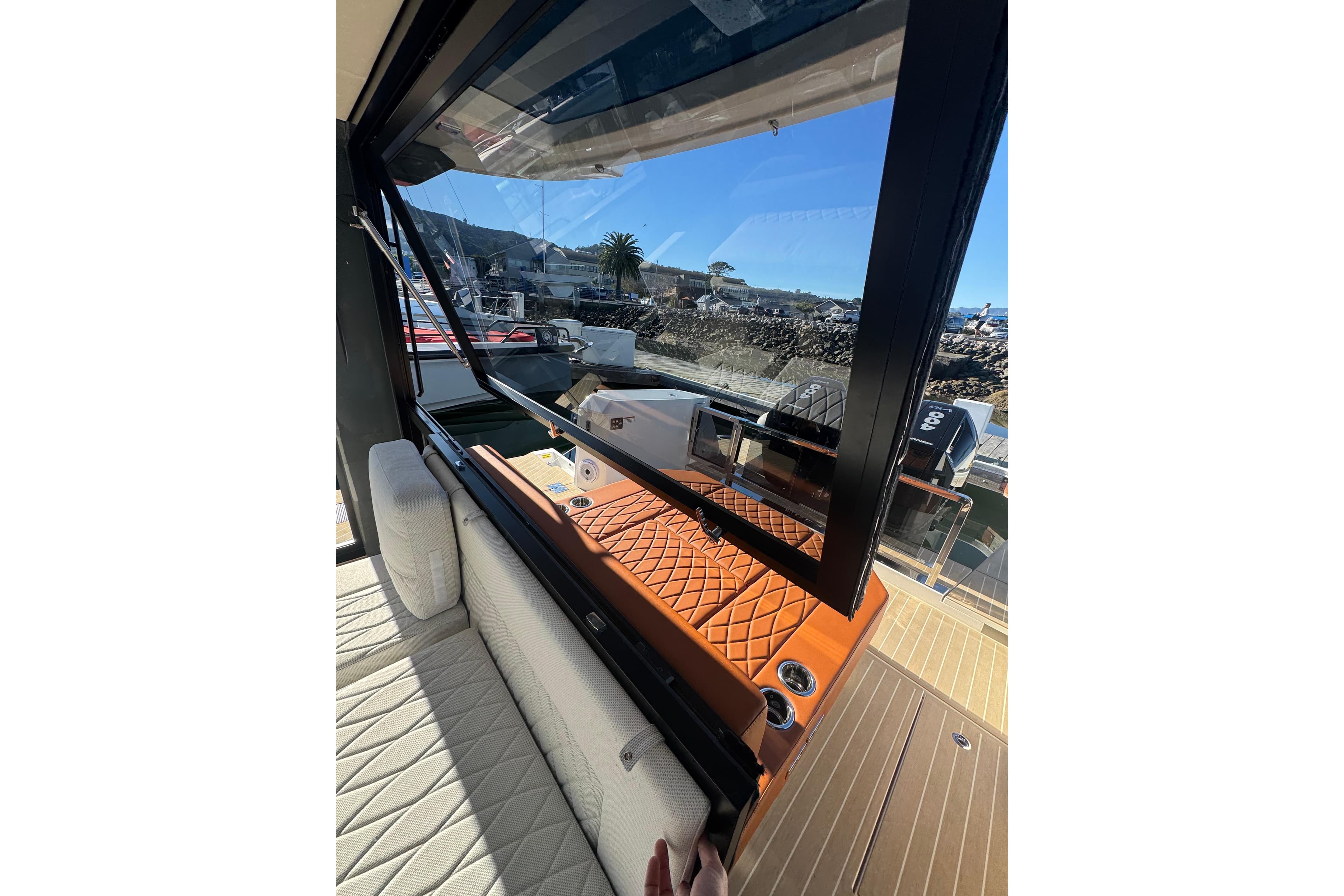 2026 Saxdor 400 GTC yacht interior with luxurious seating and open window view.