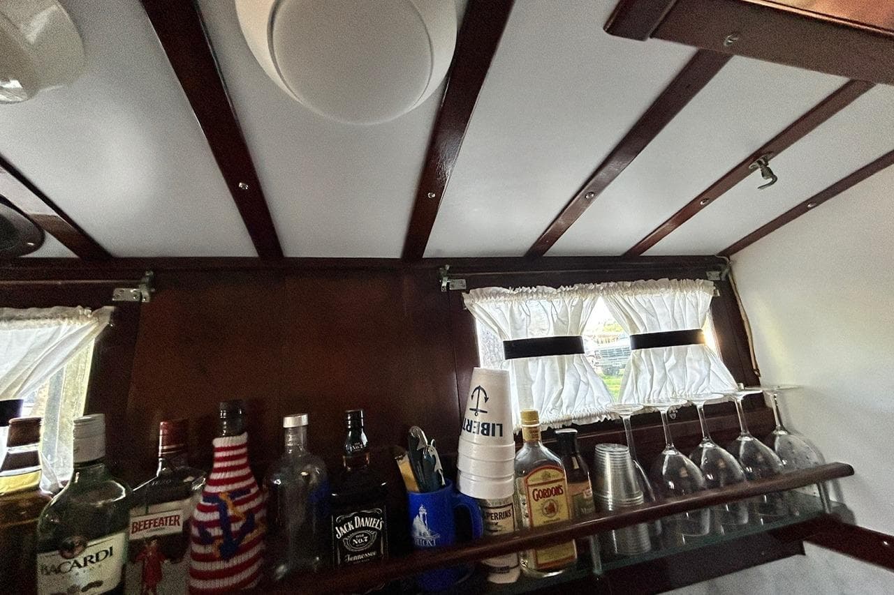 Interior of a 1930 Classic 47' ACF with a stocked bar and vintage decor.