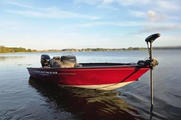 2021 Tracker Super Guide V-16 SC boat on calm lake waters.