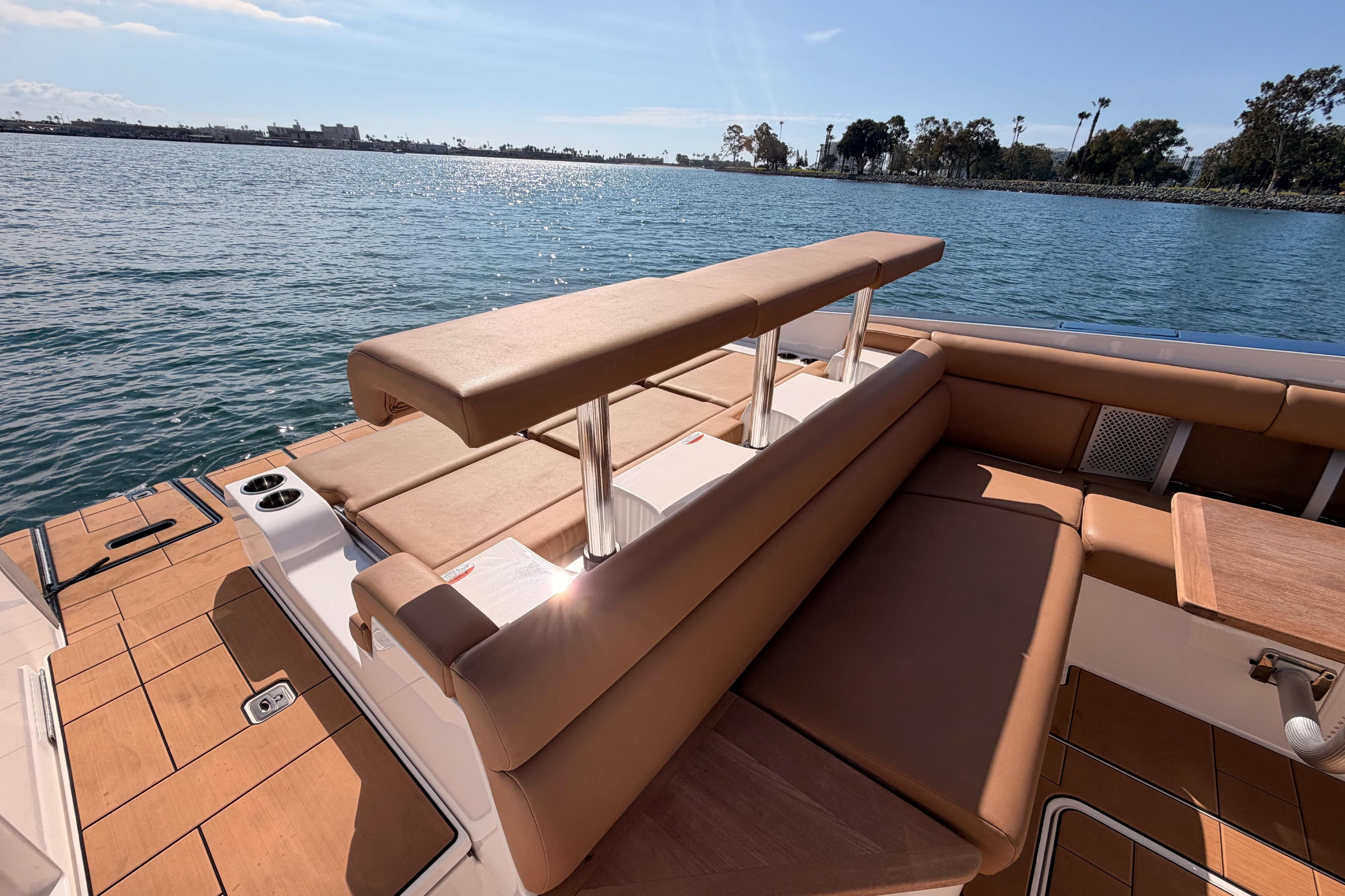 2022 Aviara AV32 I/O boat with luxurious seating, docked by a serene waterfront.