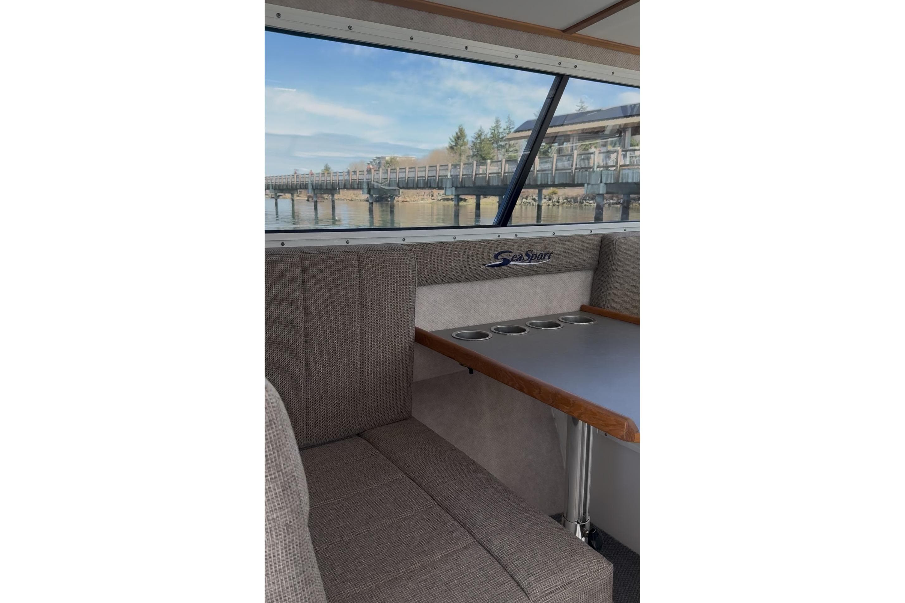Interior of 2026 SeaSport Explorer 2400 boat with window view of a pier.
