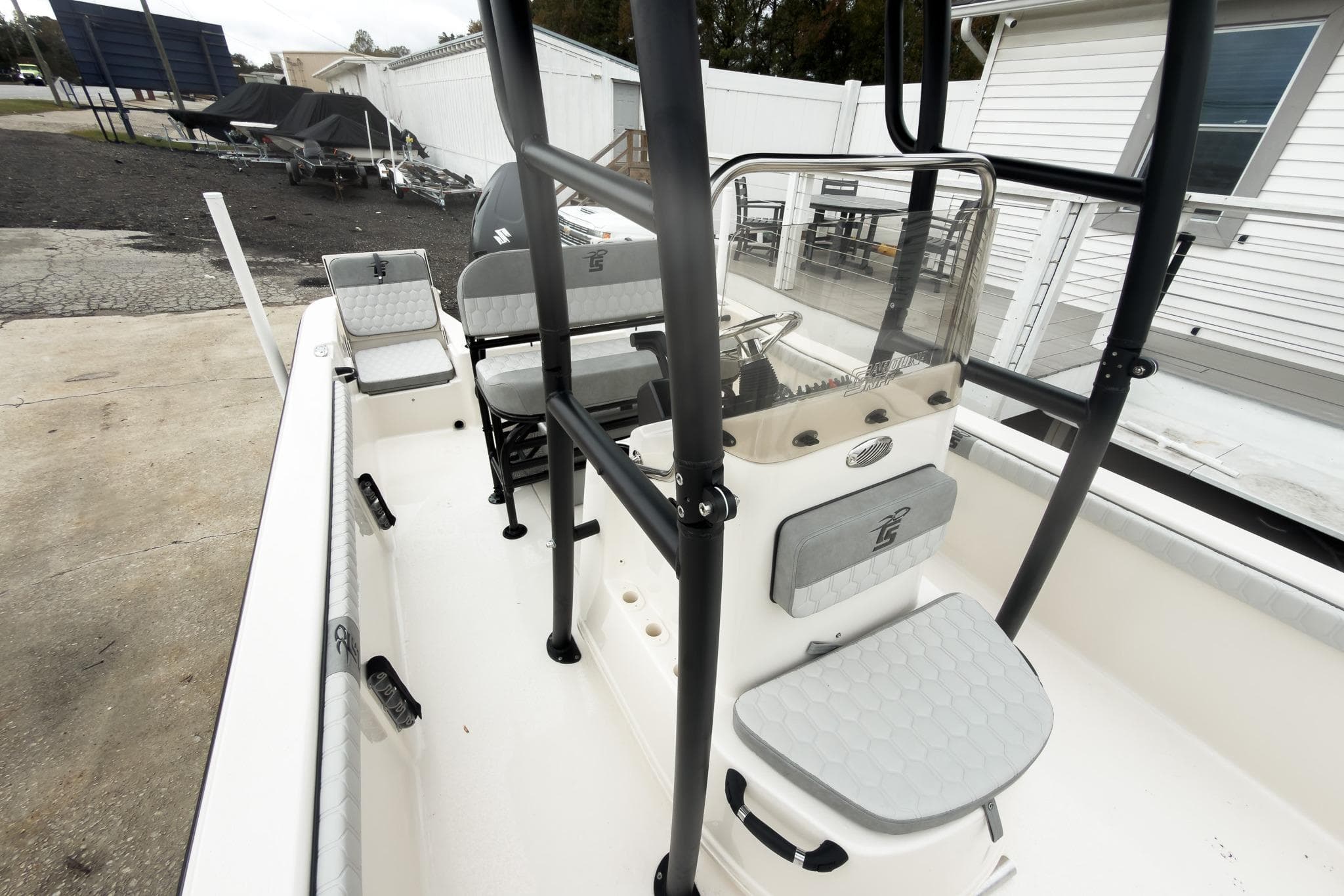 2026 Carolina Skiff 21 LS boat interior with seating and console, parked outdoors.