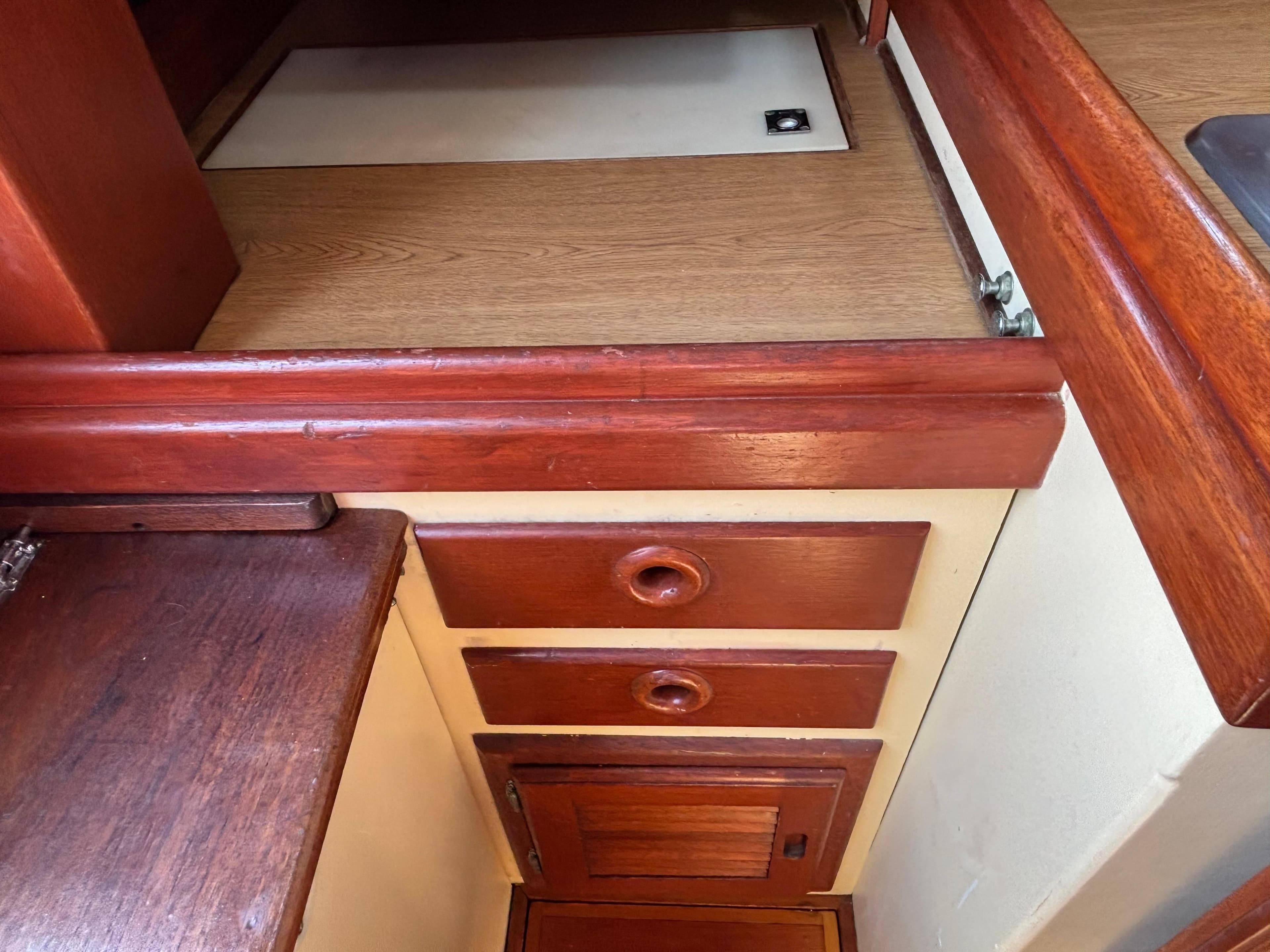 Interior of 1955 Hinckley 36 Auxiliary Yawl with wooden cabinetry and drawers.