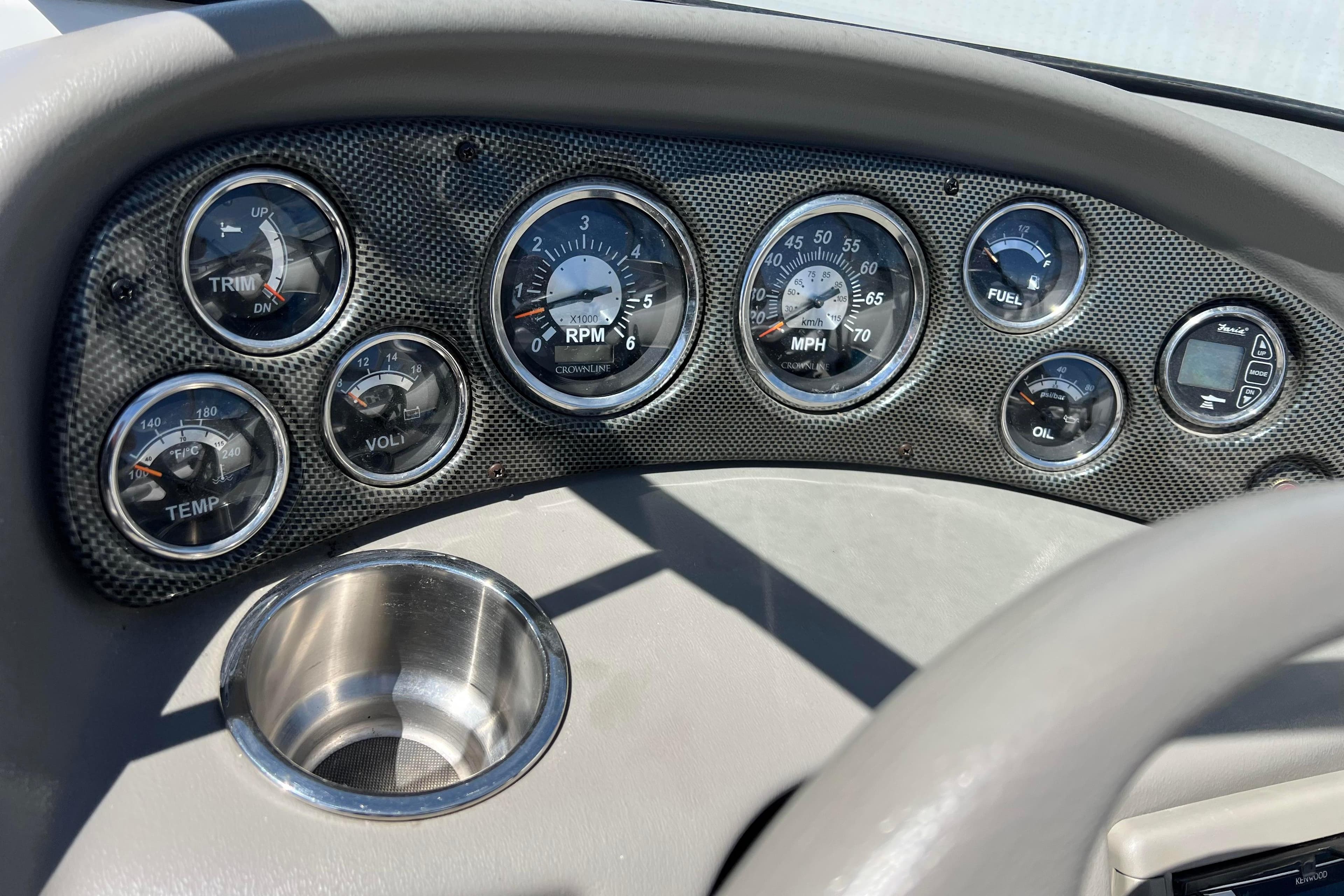 Dashboard of a 2007 Crownline 180 BR boat with gauges and cup holder.