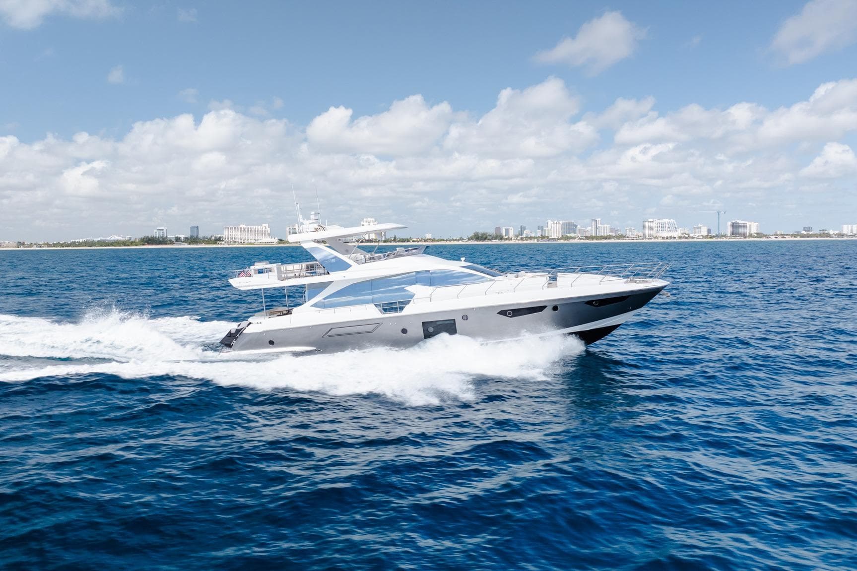 Luxurious 2017 Azimut Fly 72 yacht cruising on open blue sea under clear skies.