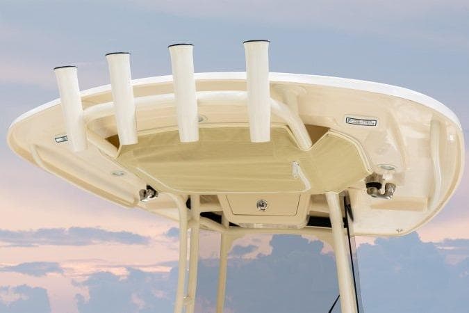 2025 Grady-White Fisherman 257 boat top with rod holders against sunset sky.