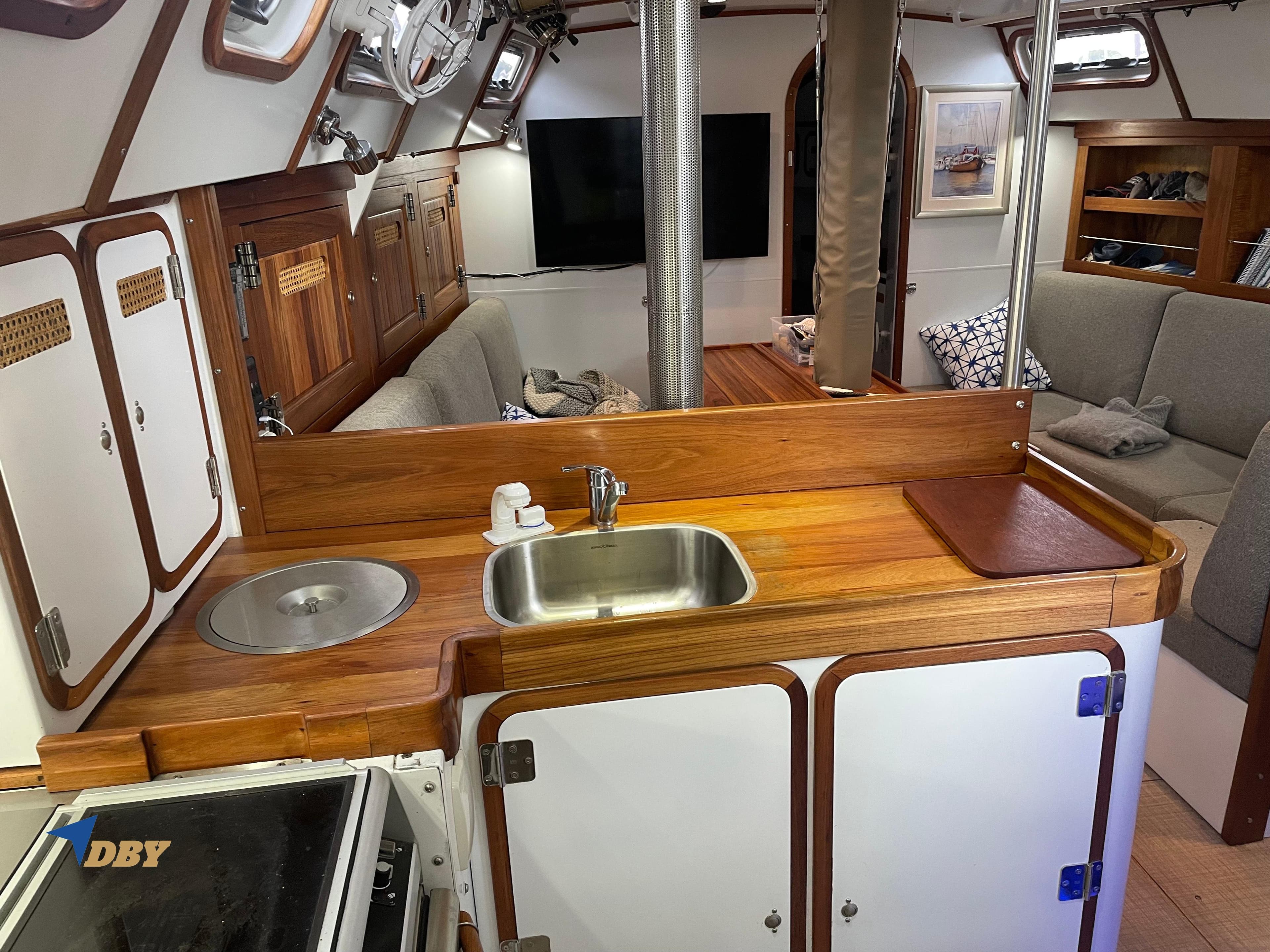 Interior of 2022 Radford 15.2 yacht with wooden kitchen and cozy seating area.