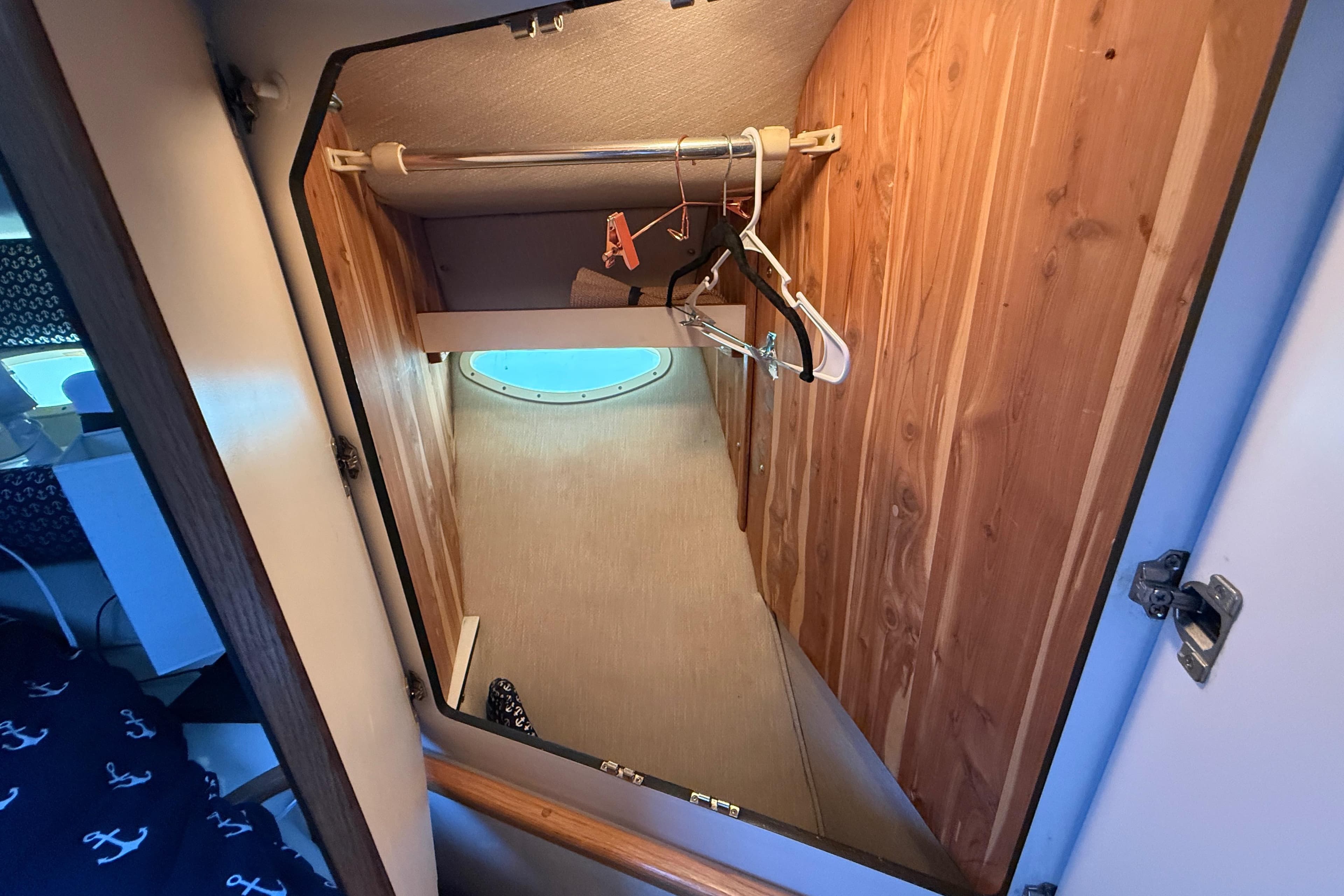 1996 Sea Ray 400 Express Cruiser closet with wooden interior and hangers.
