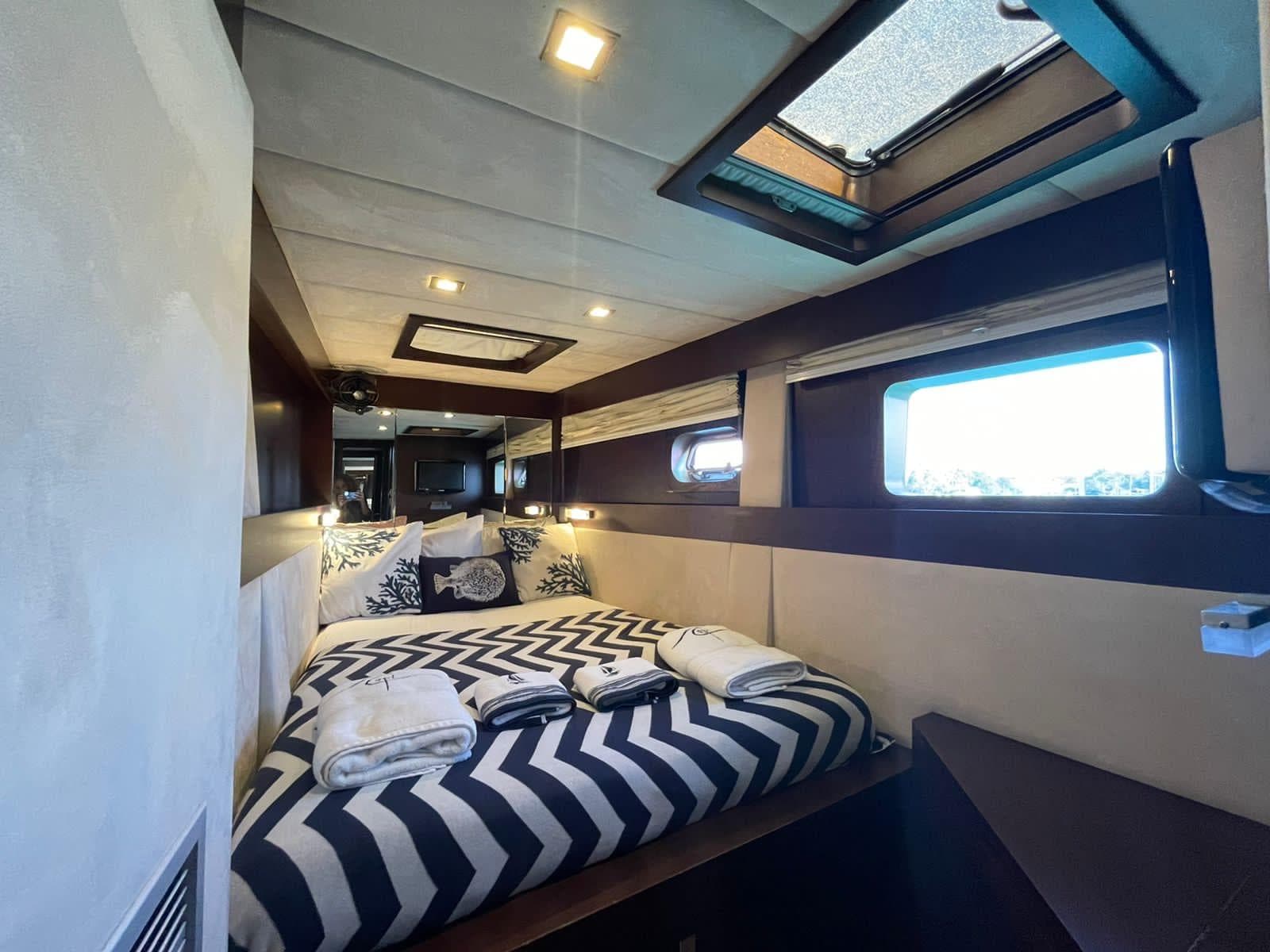 Luxurious bedroom interior of 2009 Sunreef 62 yacht with modern decor and ample natural light.