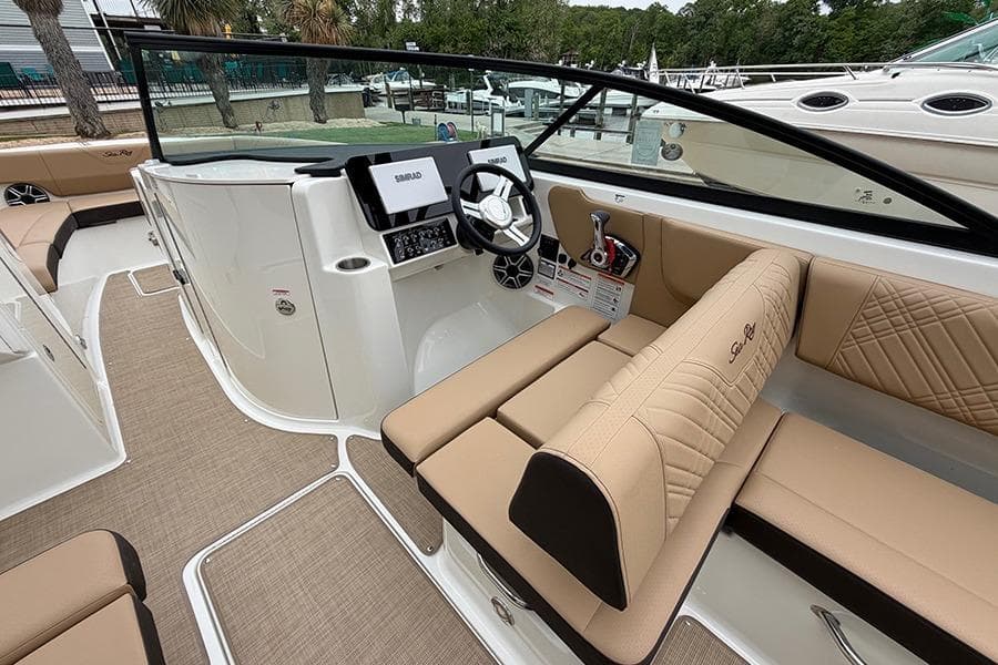 2026 Sea Ray SDX 270 Outboard boat interior with beige seating and modern dashboard.