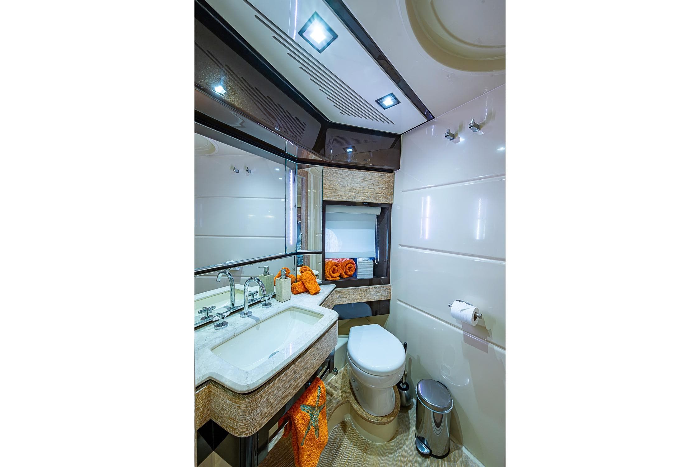 Luxurious bathroom interior of 2011 Azimut 70 yacht, featuring modern fixtures and elegant design.