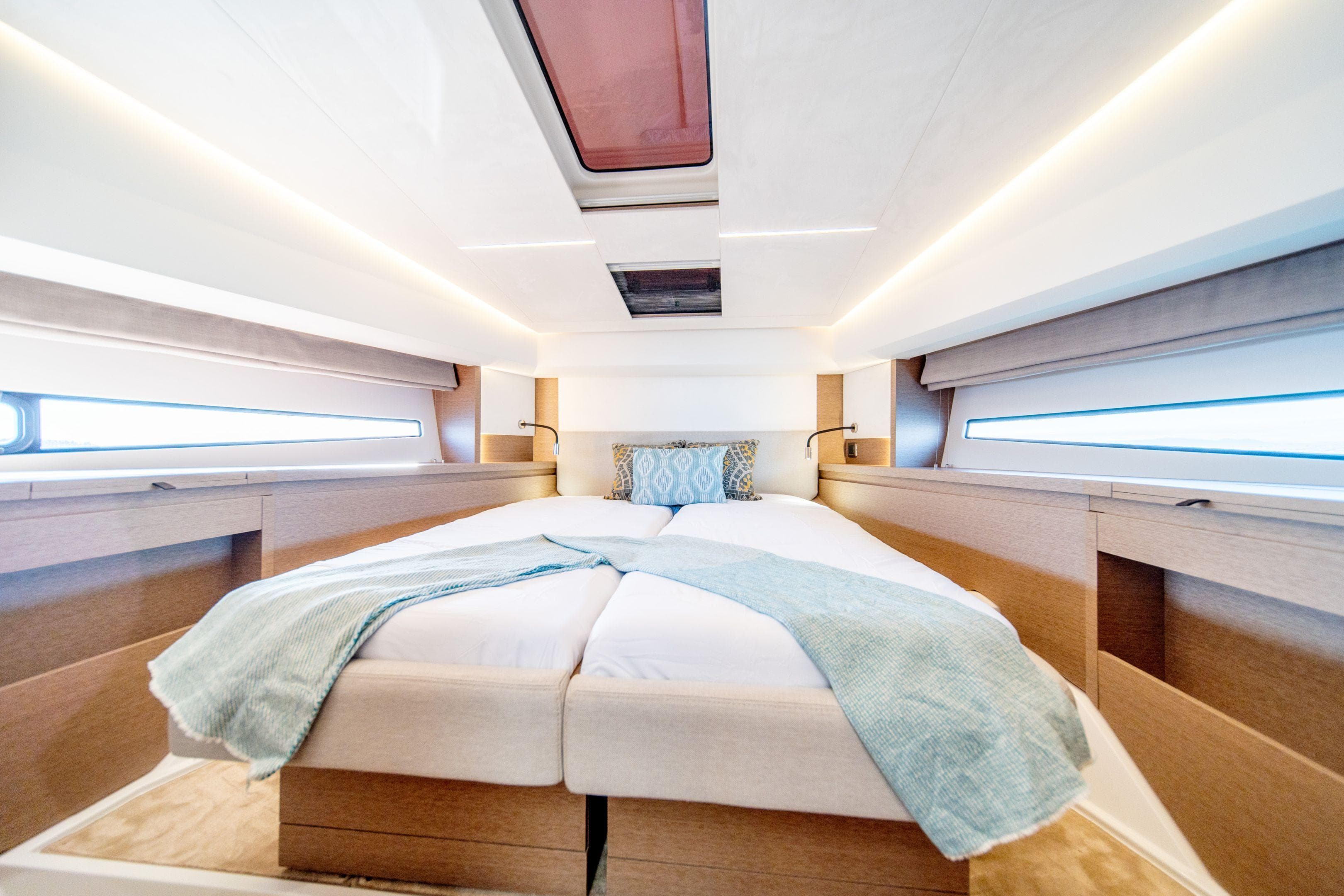 Luxurious bedroom interior of 2024 Prestige 460 Fly yacht with modern design and skylight.