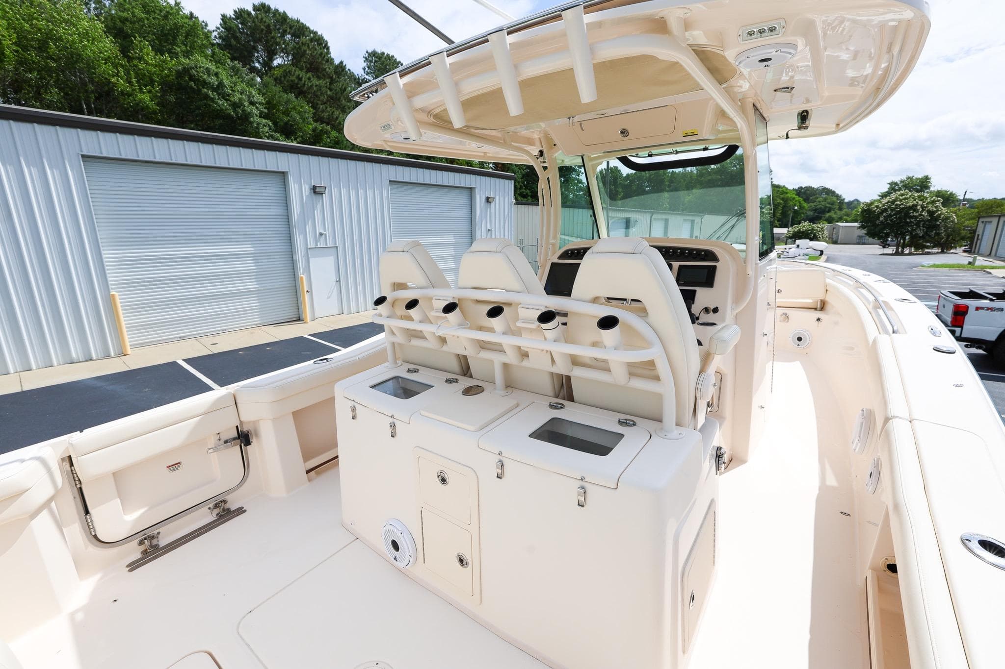 2020 Grady-White Canyon 336 boat interior with seating and storage, docked near industrial buildings.