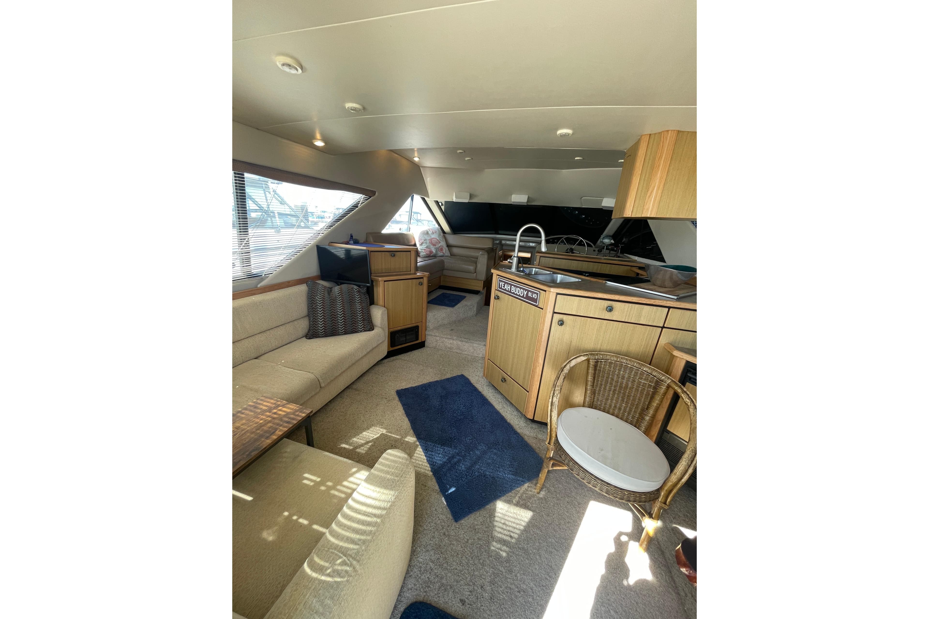 Interior of 2001 Bayliner 3988 Command Bridge Motoryacht with cozy seating and modern kitchen.