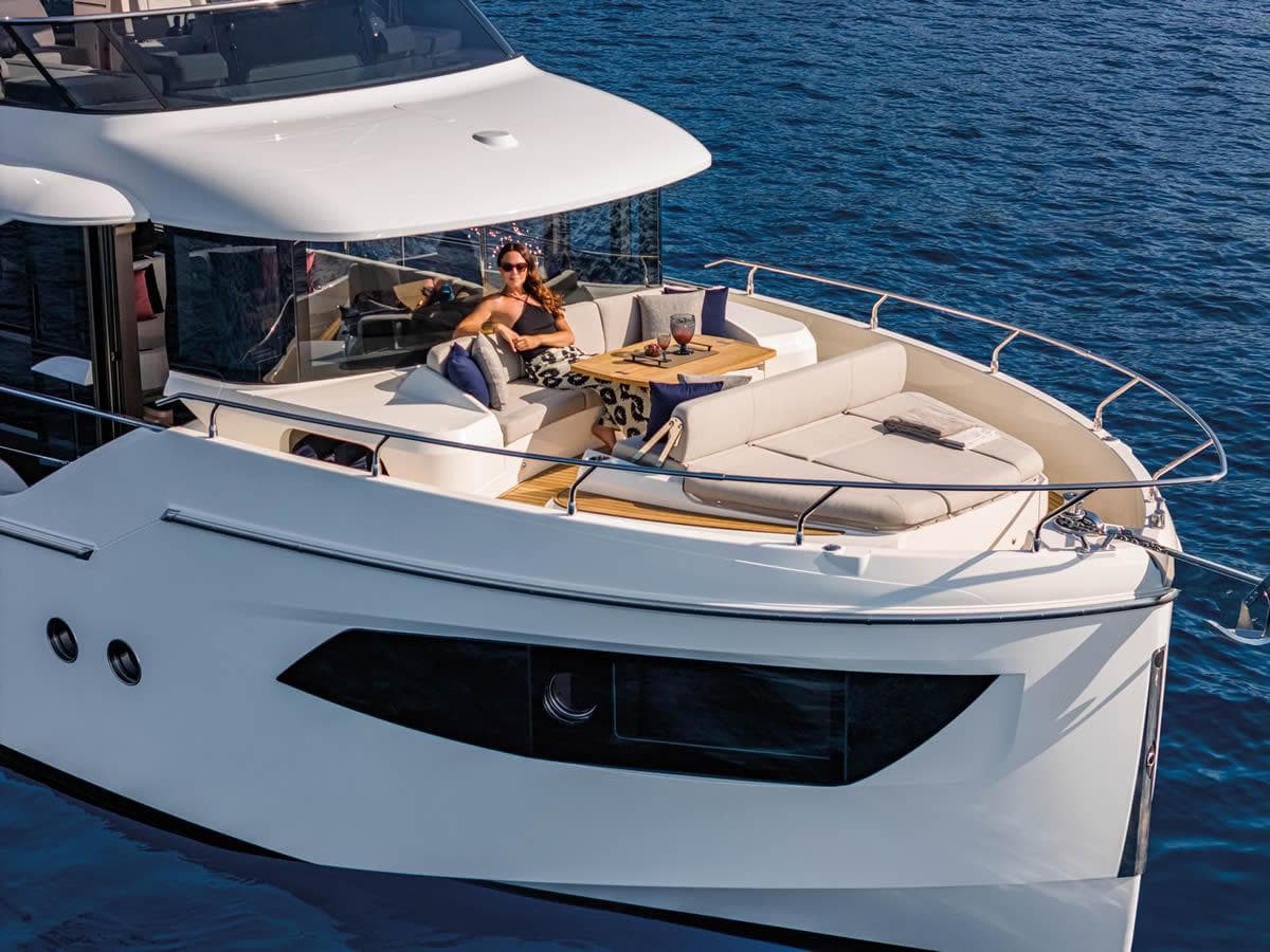 Luxury 2025 Absolute 53 Navetta yacht with sunbathing area on open sea.