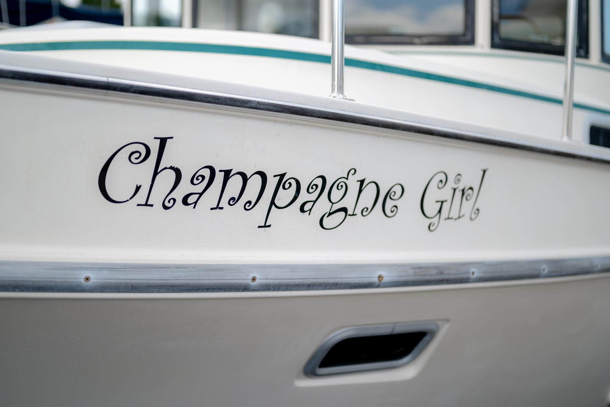Close-up of "Champagne Girl" boat name on 1996 Camano 31.