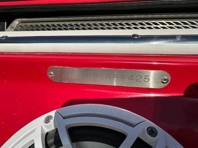 2025 Regal LS9 Surf boat with red exterior and visible speaker detail.