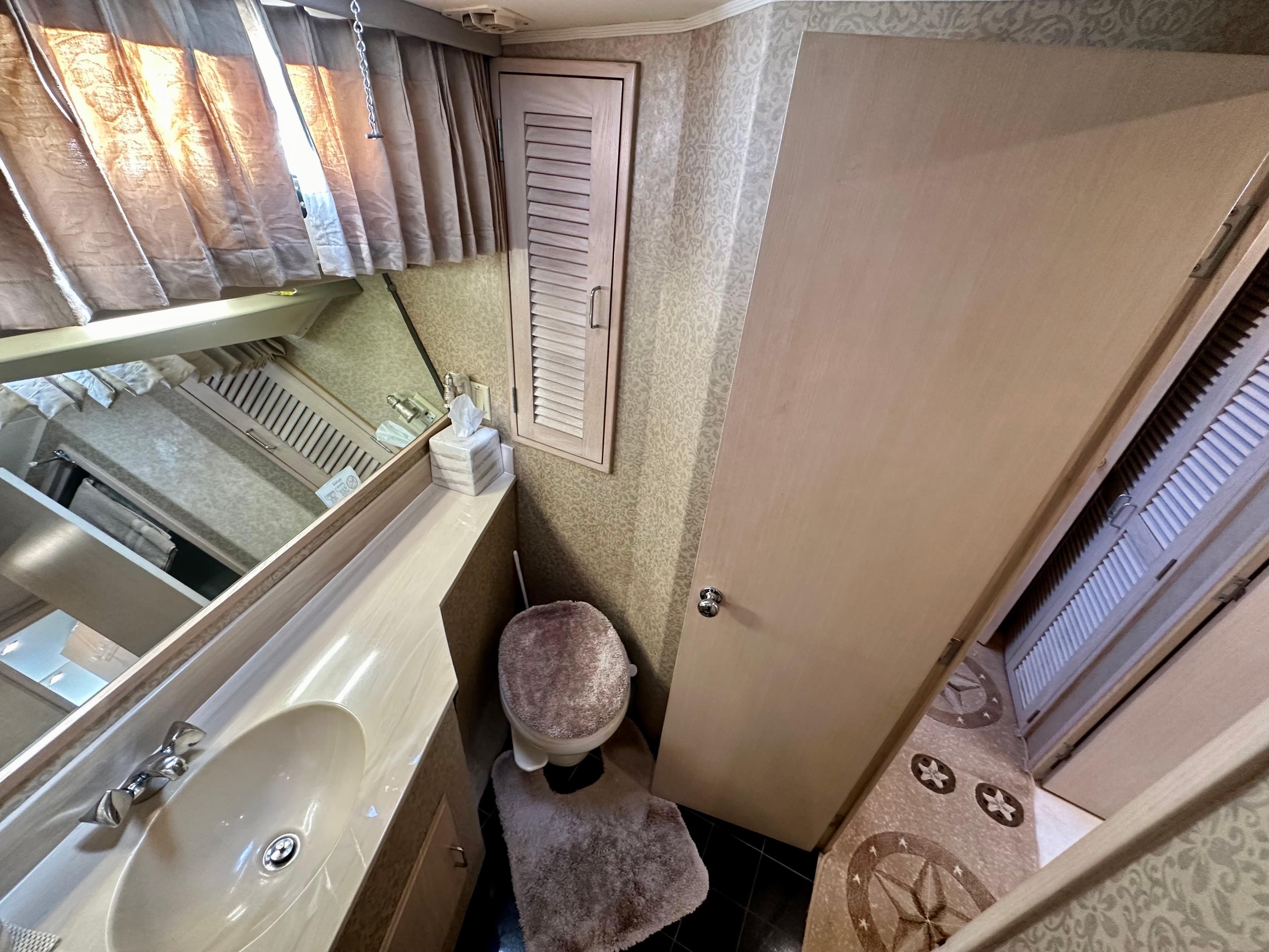 1993 Tollycraft 57 Pilothouse bathroom interior view.