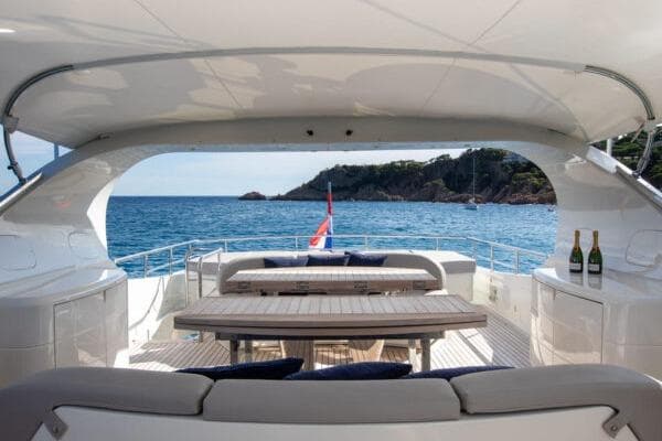 Luxurious 2009 Maiora 31DP yacht deck with ocean view and elegant seating area.