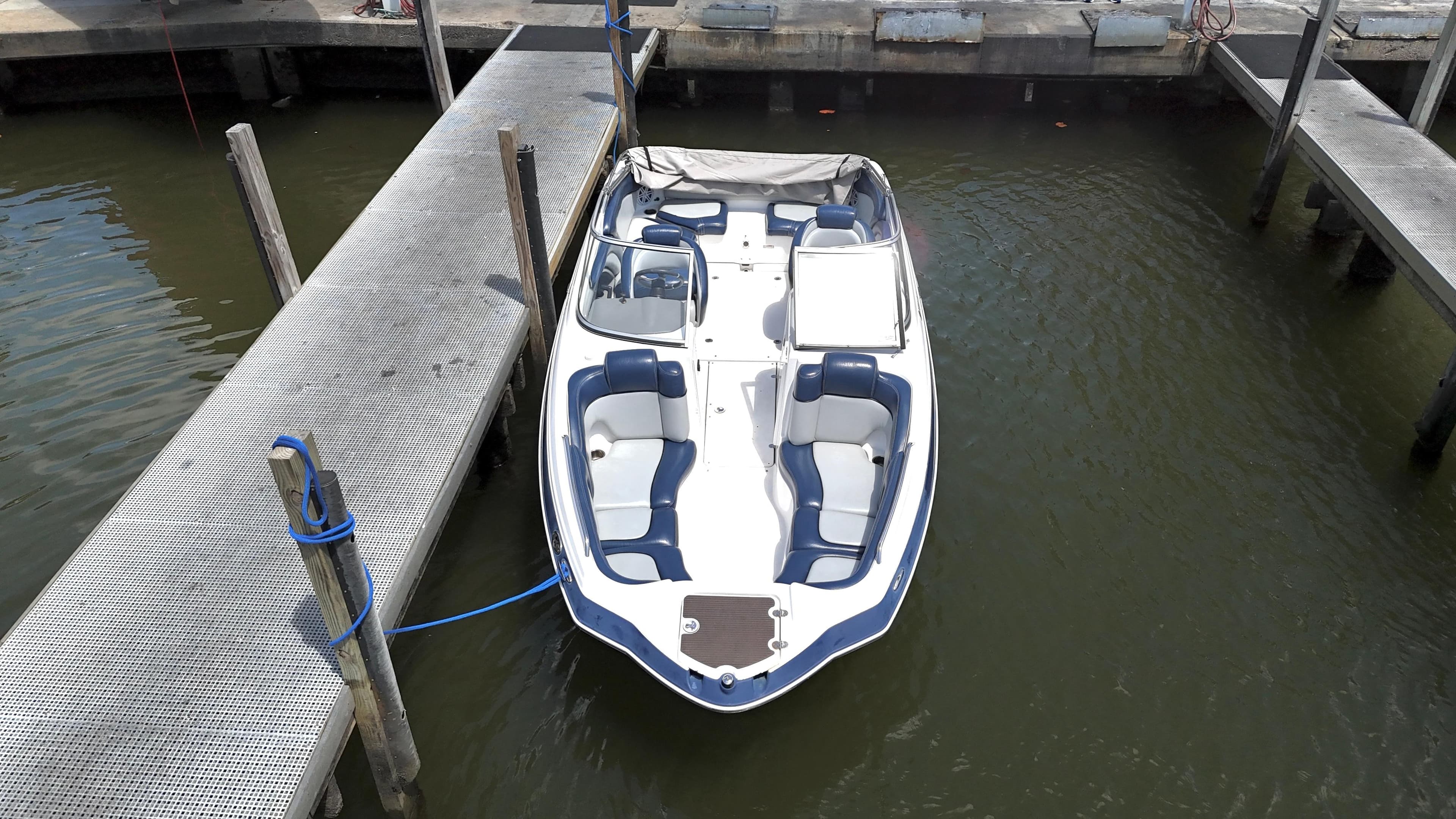2011 Yamaha Boats 242 Limited docked, aerial view, white and blue design.