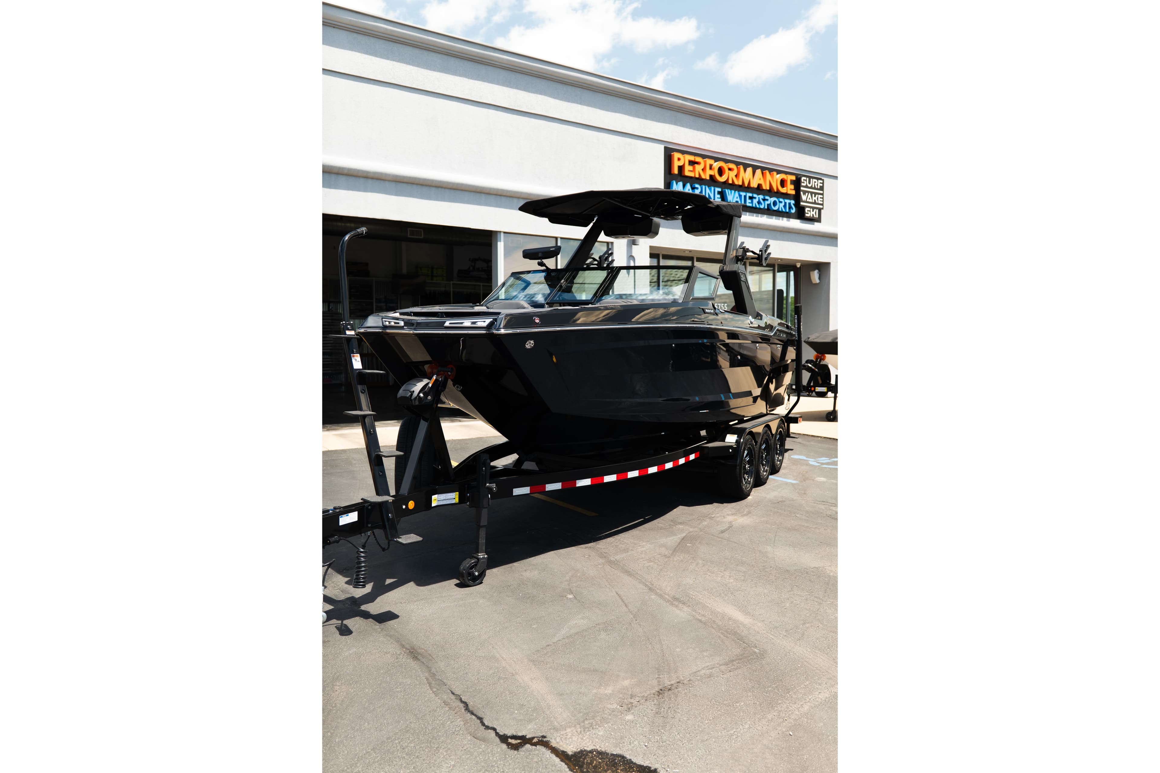 2026 MasterCraft XStar 25 boat on trailer at Performance Marine Watersports dealership.