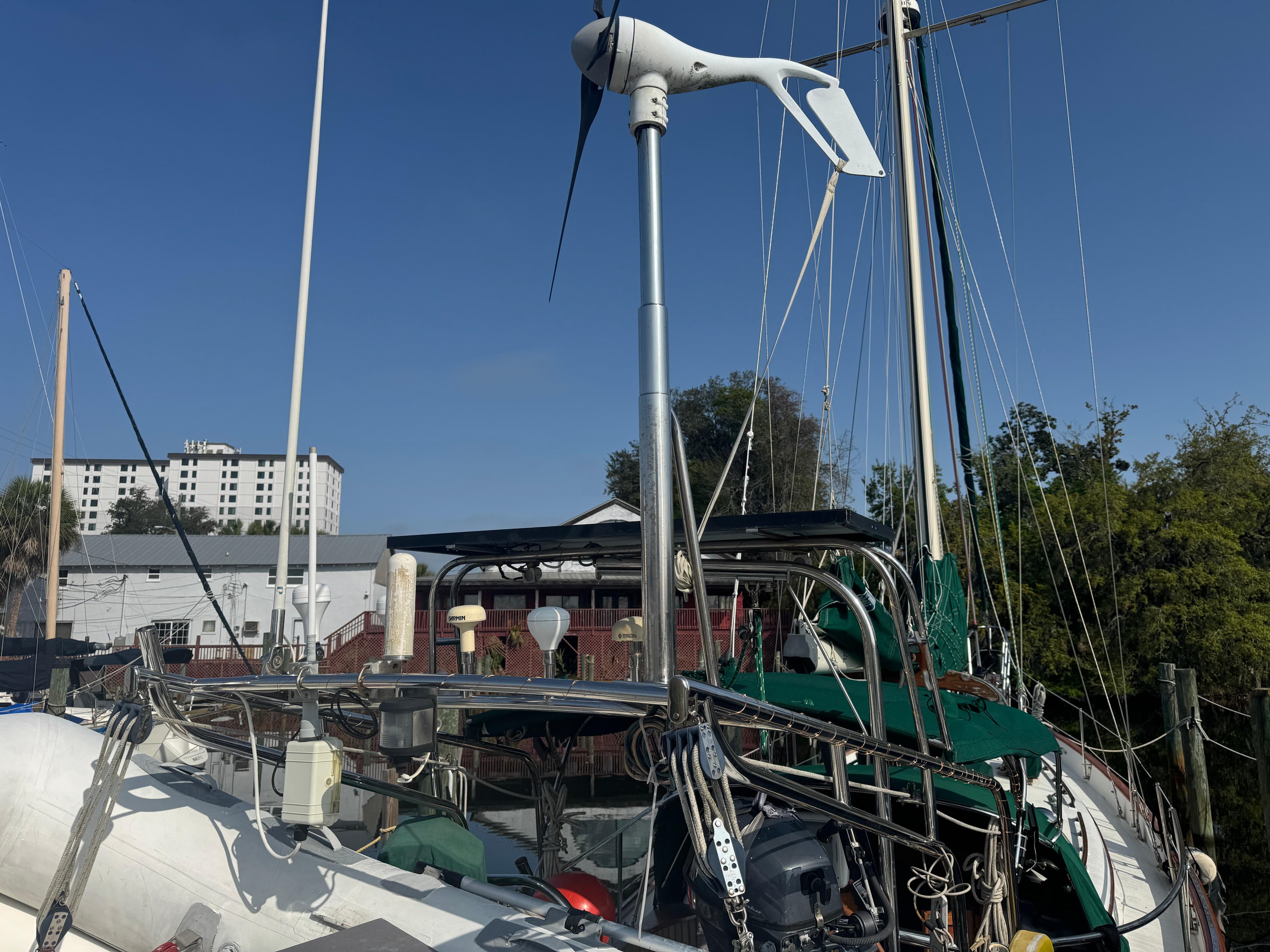 Sailboat Hans Christian 43T, 1989 model, docked with visible wind turbine and rigging.