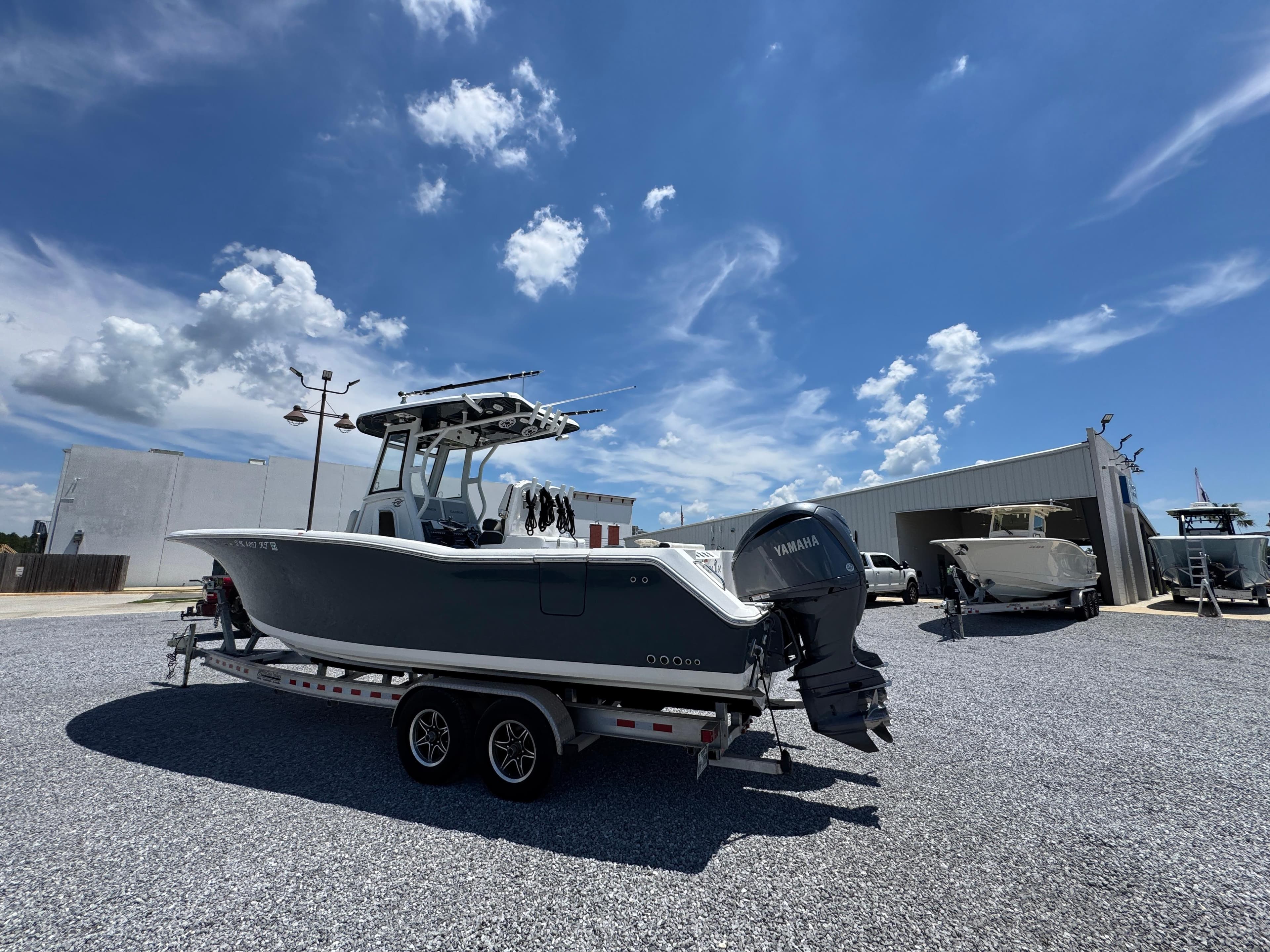 2023 Tidewater 282 CC Adventure Bluewater boat on trailer under clear sky.
