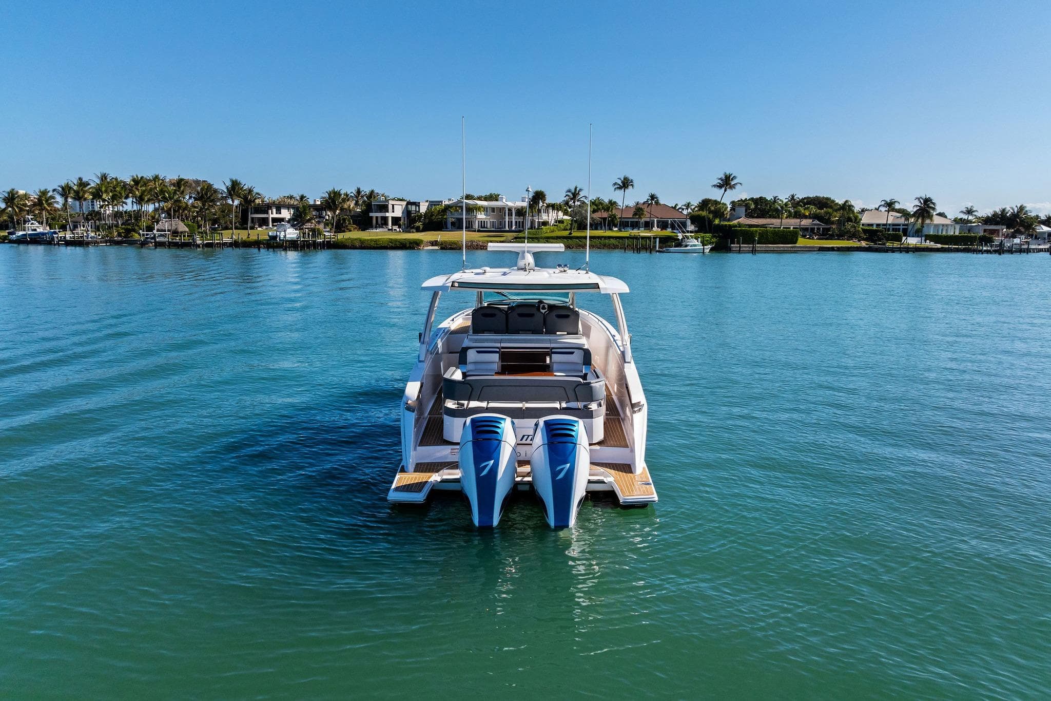 2019 Tiara Yachts 38 LS on serene water with scenic coastal backdrop.