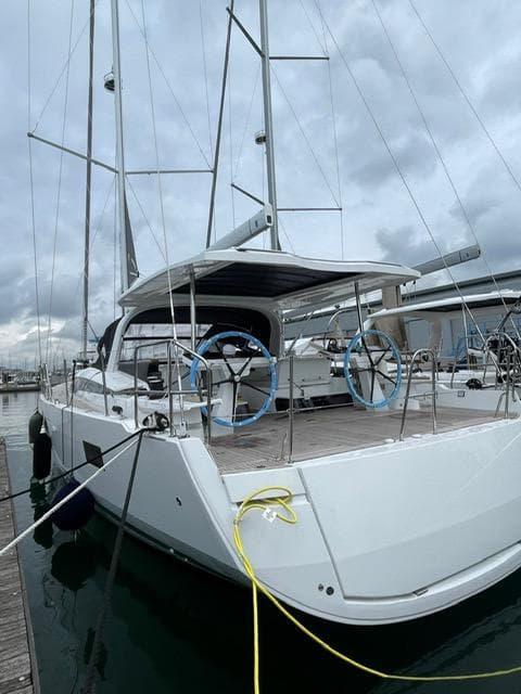 2023 Jeanneau 65 sailboat docked, showcasing sleek design and modern features.