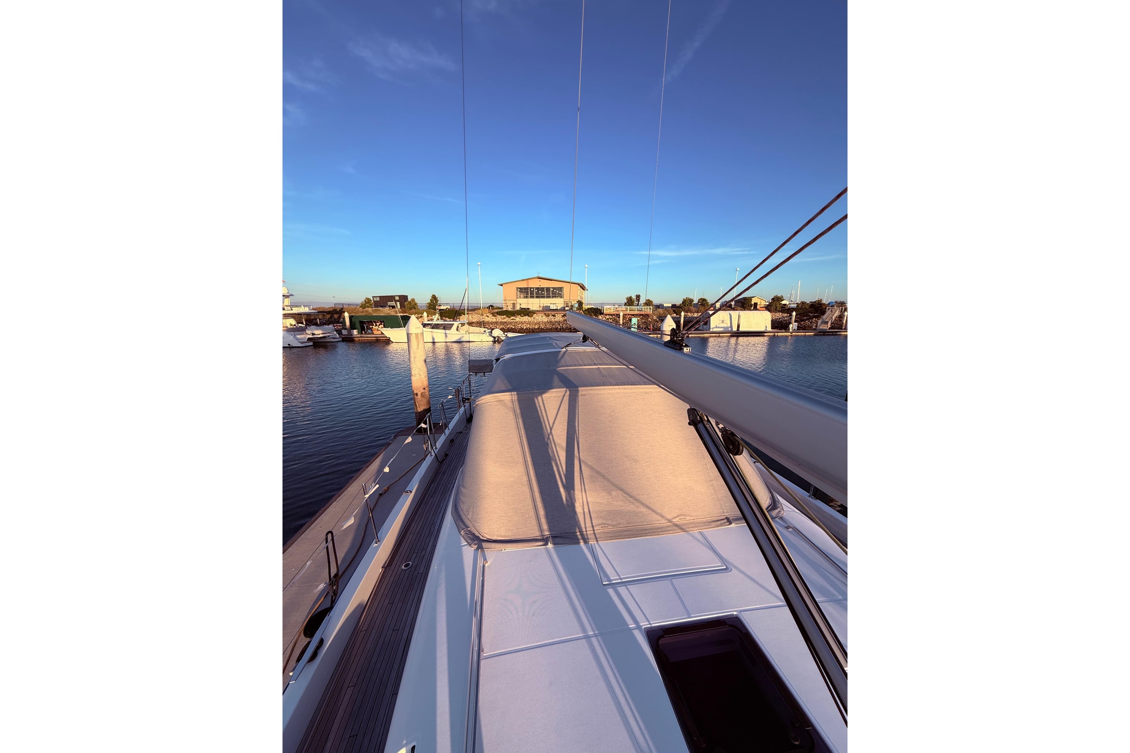 Beneteau Oceanis Yacht 54, 2022 model, docked at marina during sunset.
