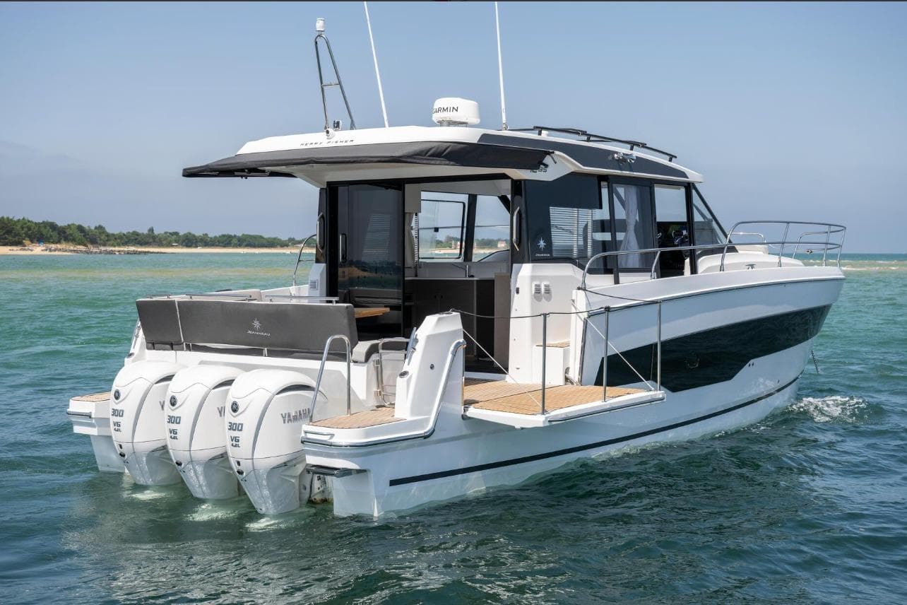 2026 Jeanneau NC 1295 Weekender boat with triple Yamaha engines on open water.
