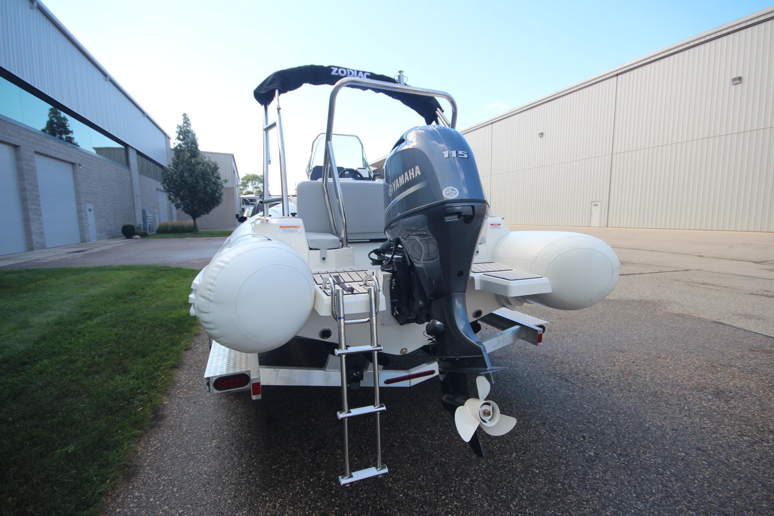 2025 Zodiac Medline 5.8 NEO boat with Yamaha 115hp engine, parked outdoors.