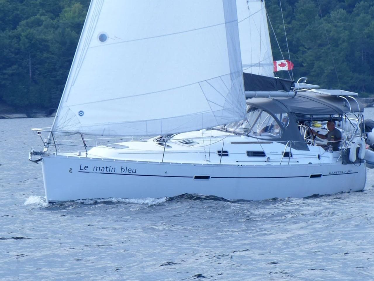 2008 Beneteau 343 sailboat on water with Canadian flag.