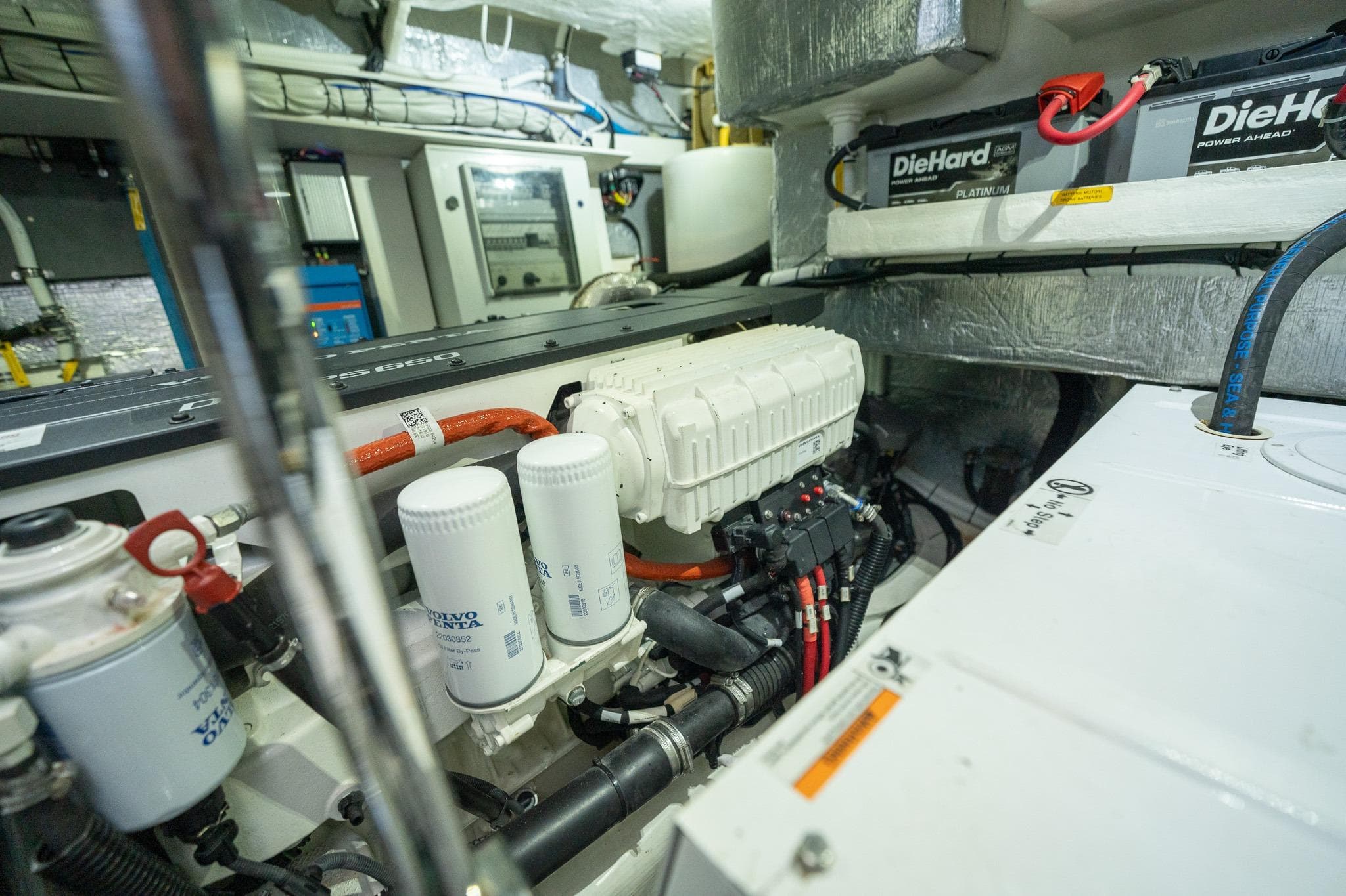 Engine room of 2020 Absolute 50 Fly yacht with DieHard batteries and Volvo Penta components.