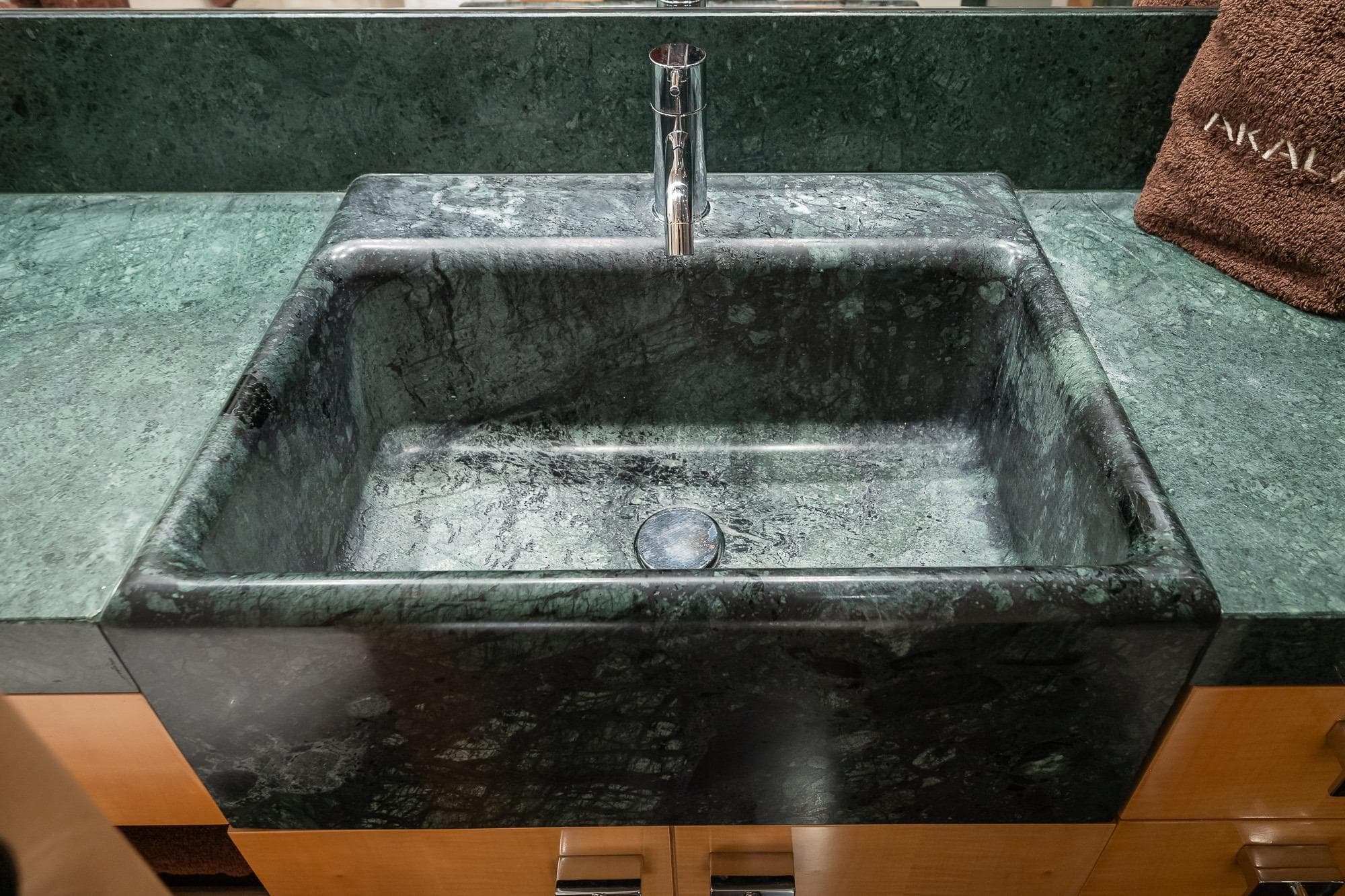 Luxurious green marble sink with modern faucet on Pendennis 105 yacht, 2011 model.