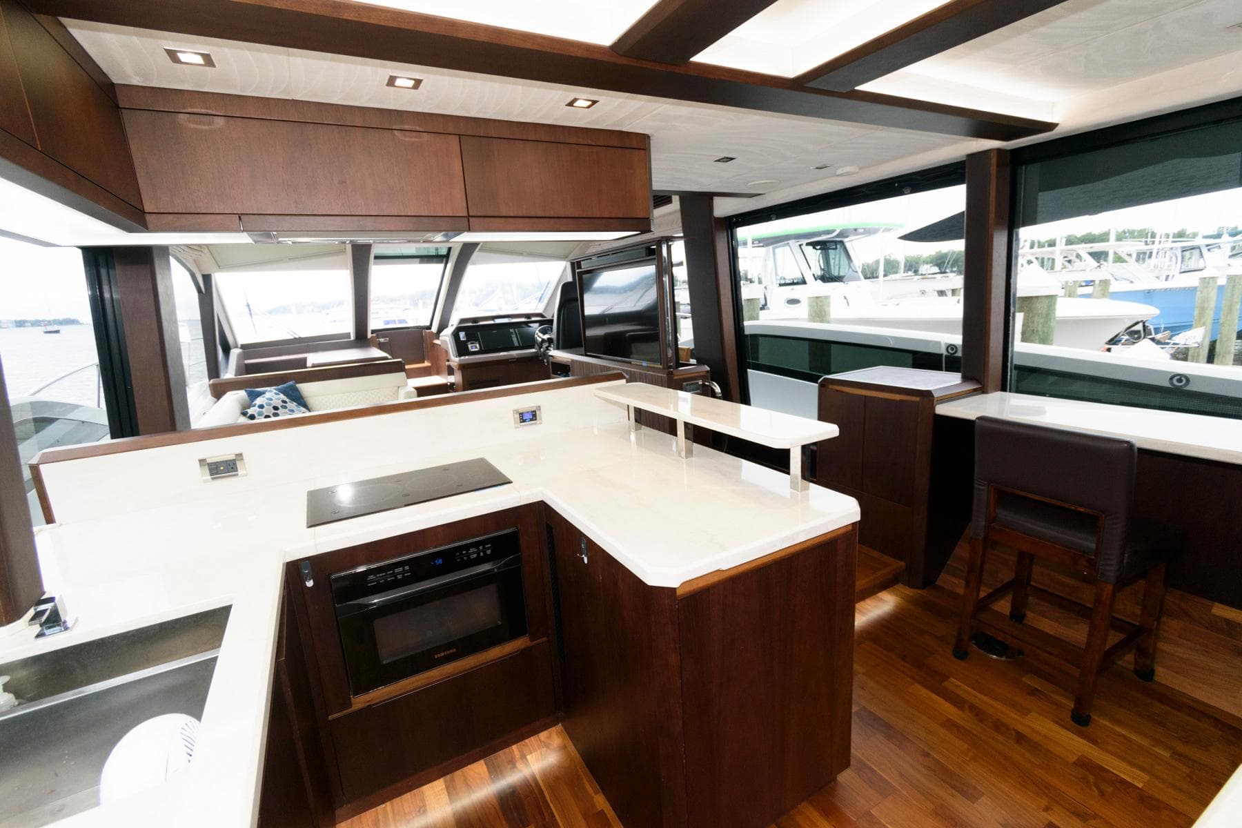 Luxurious interior of 2018 Galeon 640 Fly yacht with modern kitchen and seating area.
