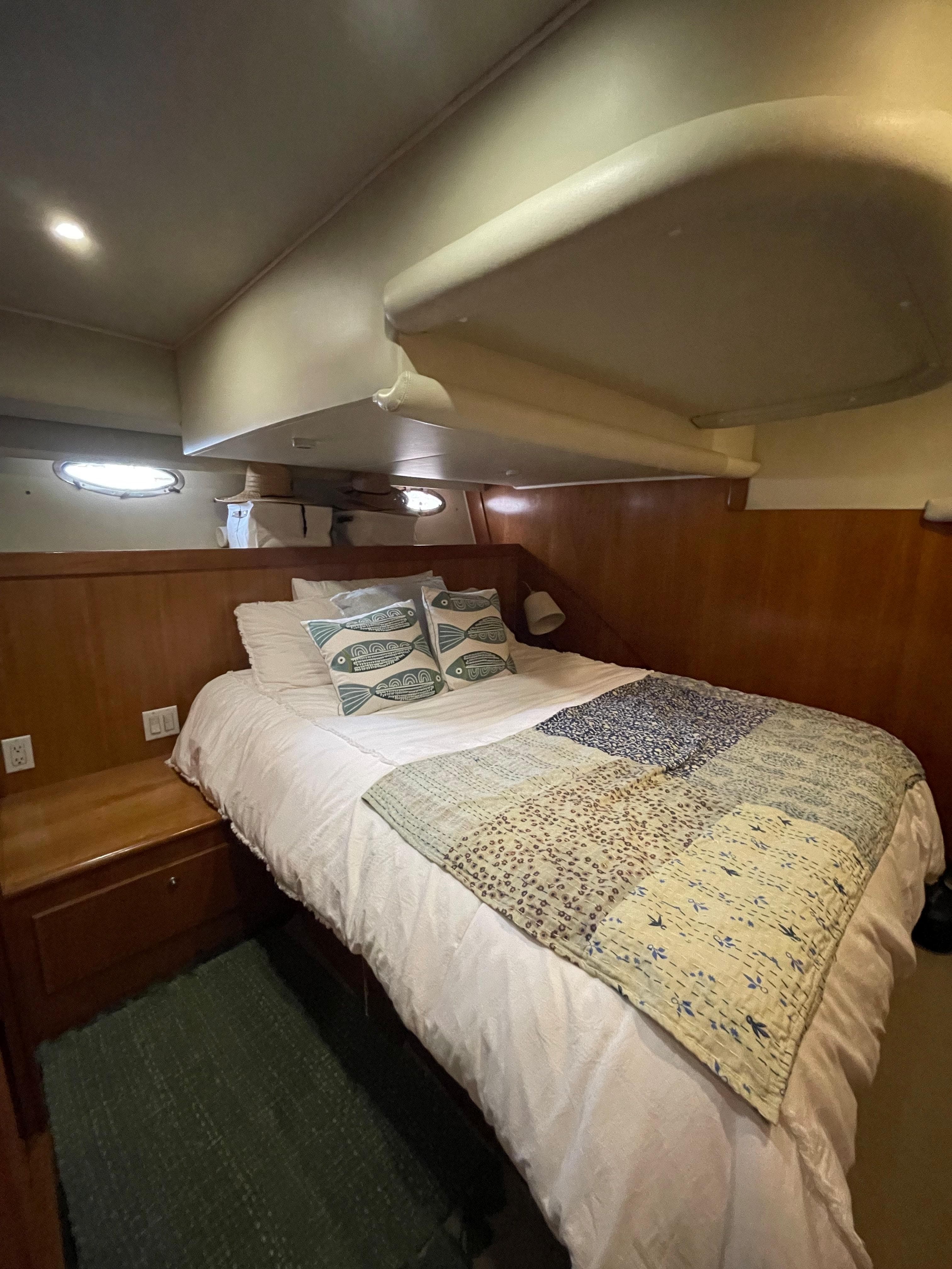 Cozy bedroom in 2001 Navigator Californian 3900 yacht with quilted bedding.