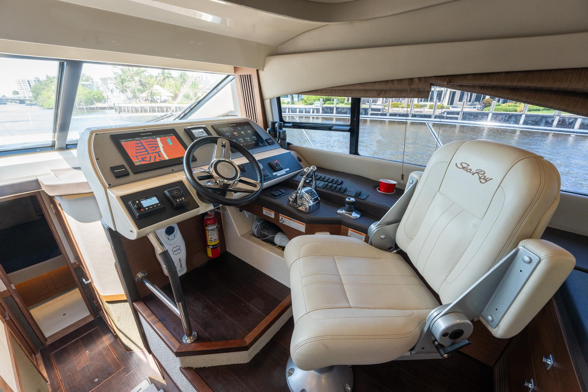 Helm station of 2016 Sea Ray 510 Fly yacht with leather captain's chair.