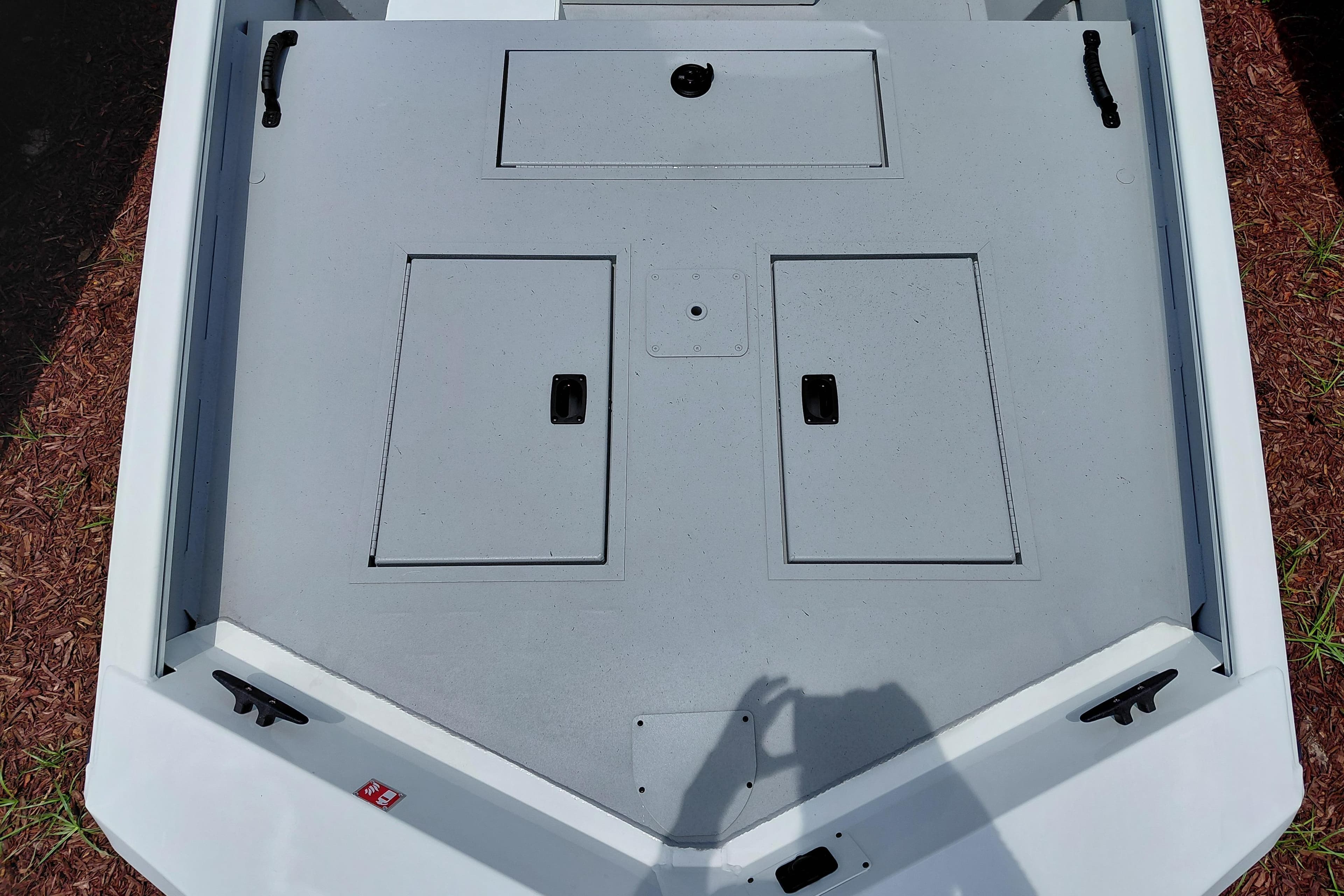 2026 Lowe Roughneck RX1860 CC boat deck with storage compartments and handles.
