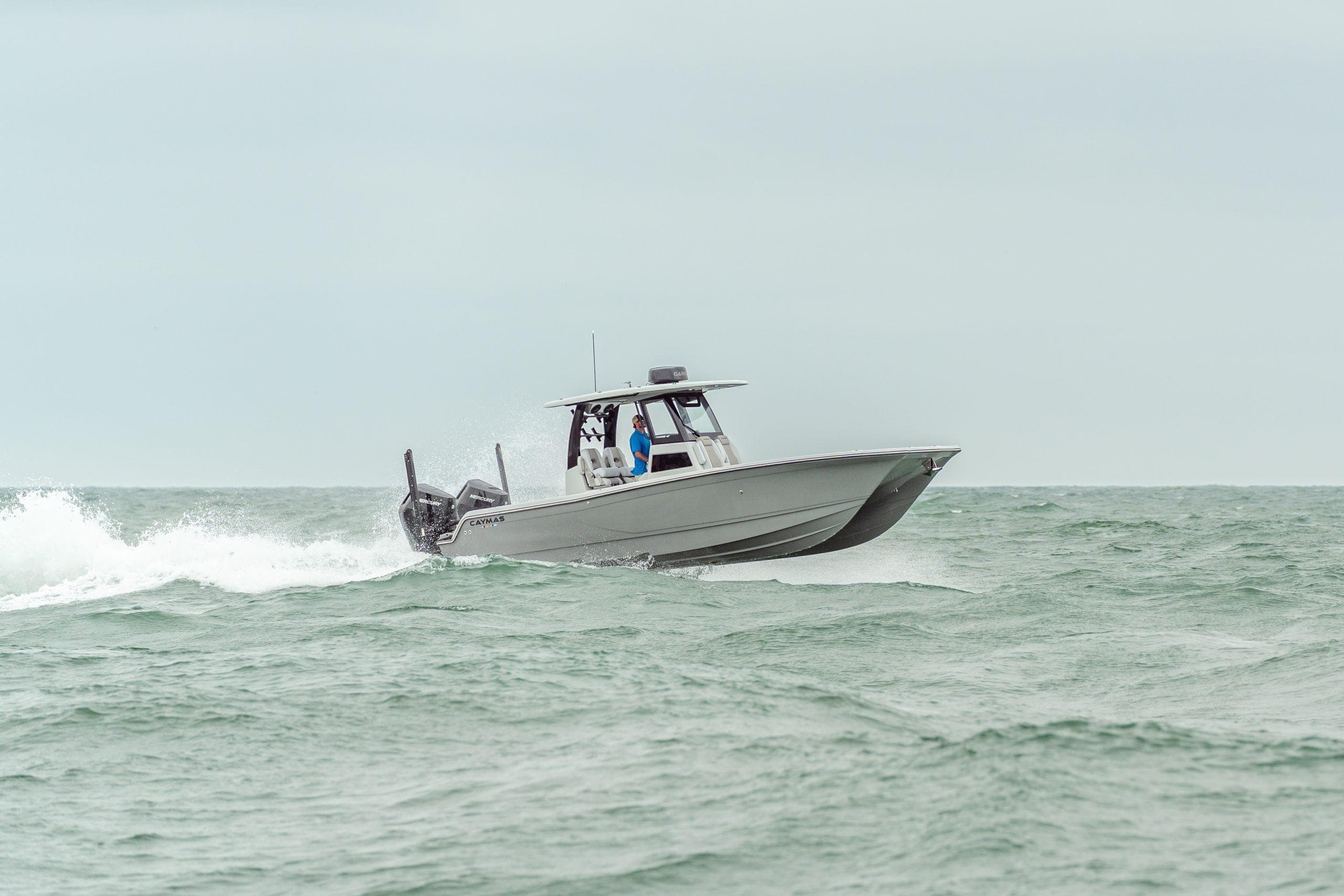 2027 Caymas 29 CT boat cruising on open sea.