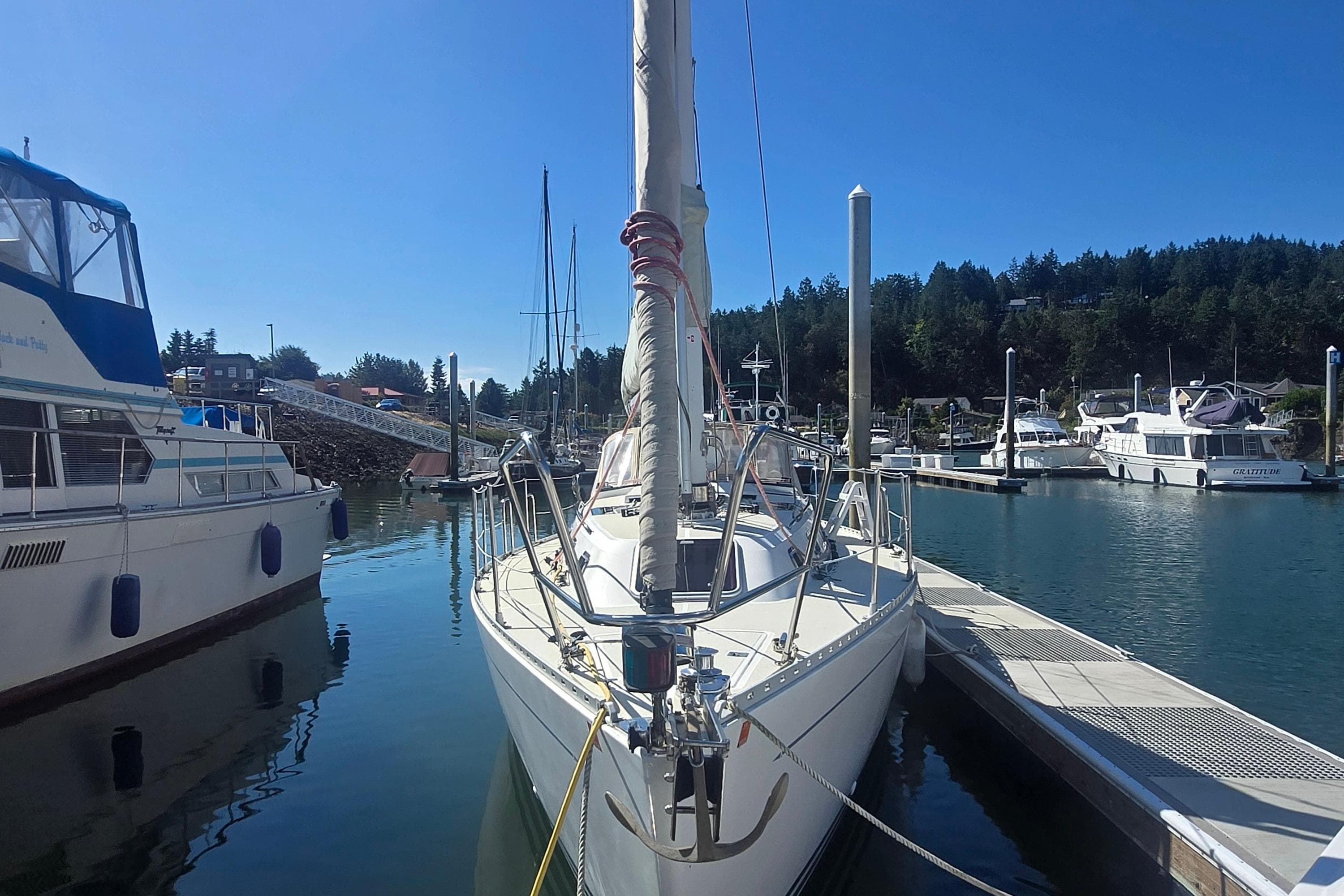 Sailboat Freedom 35, 1997 model, docked in a marina under clear blue skies.
