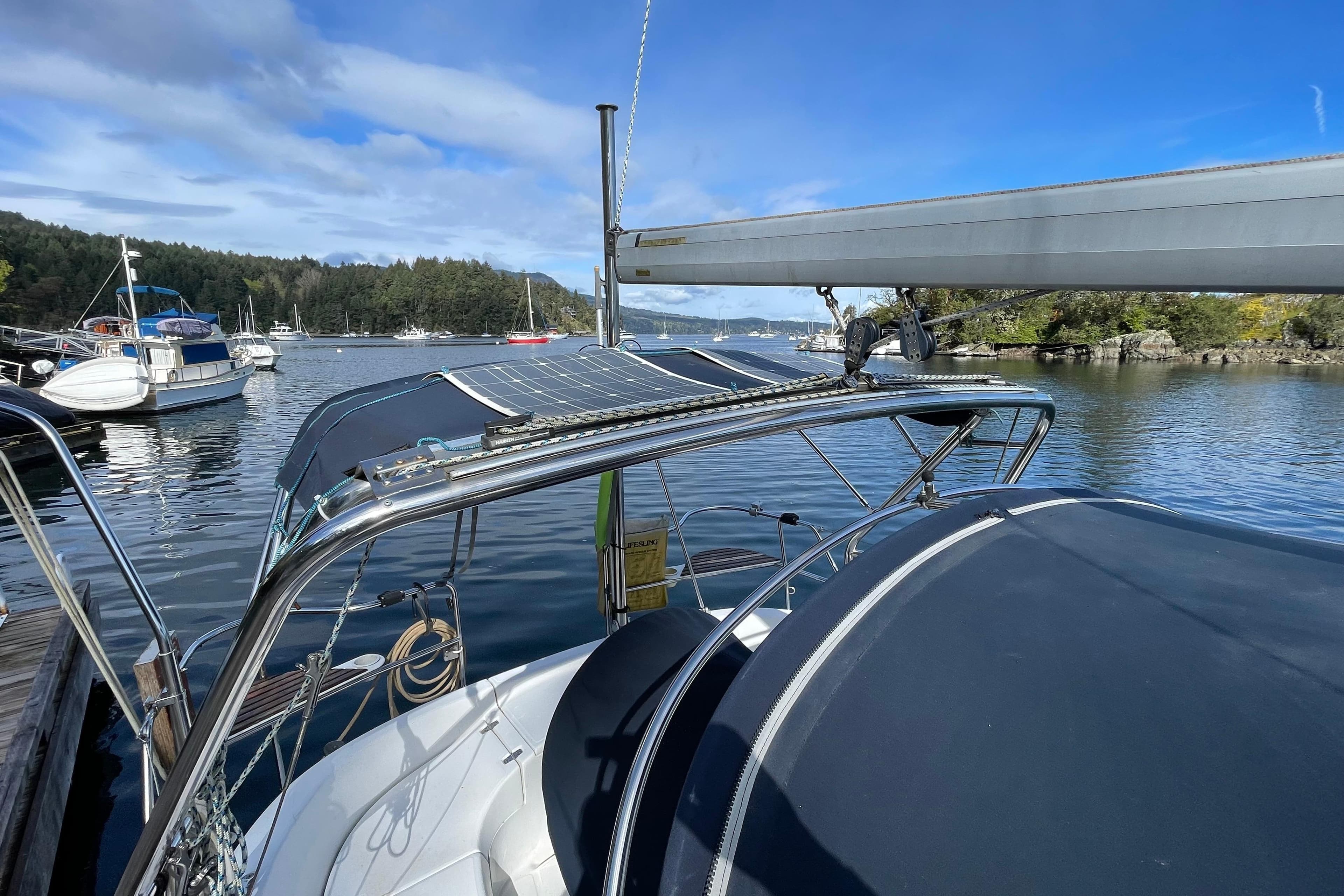 Sailboat docked in a scenic marina, featuring a 2000 Hunter 340 model.