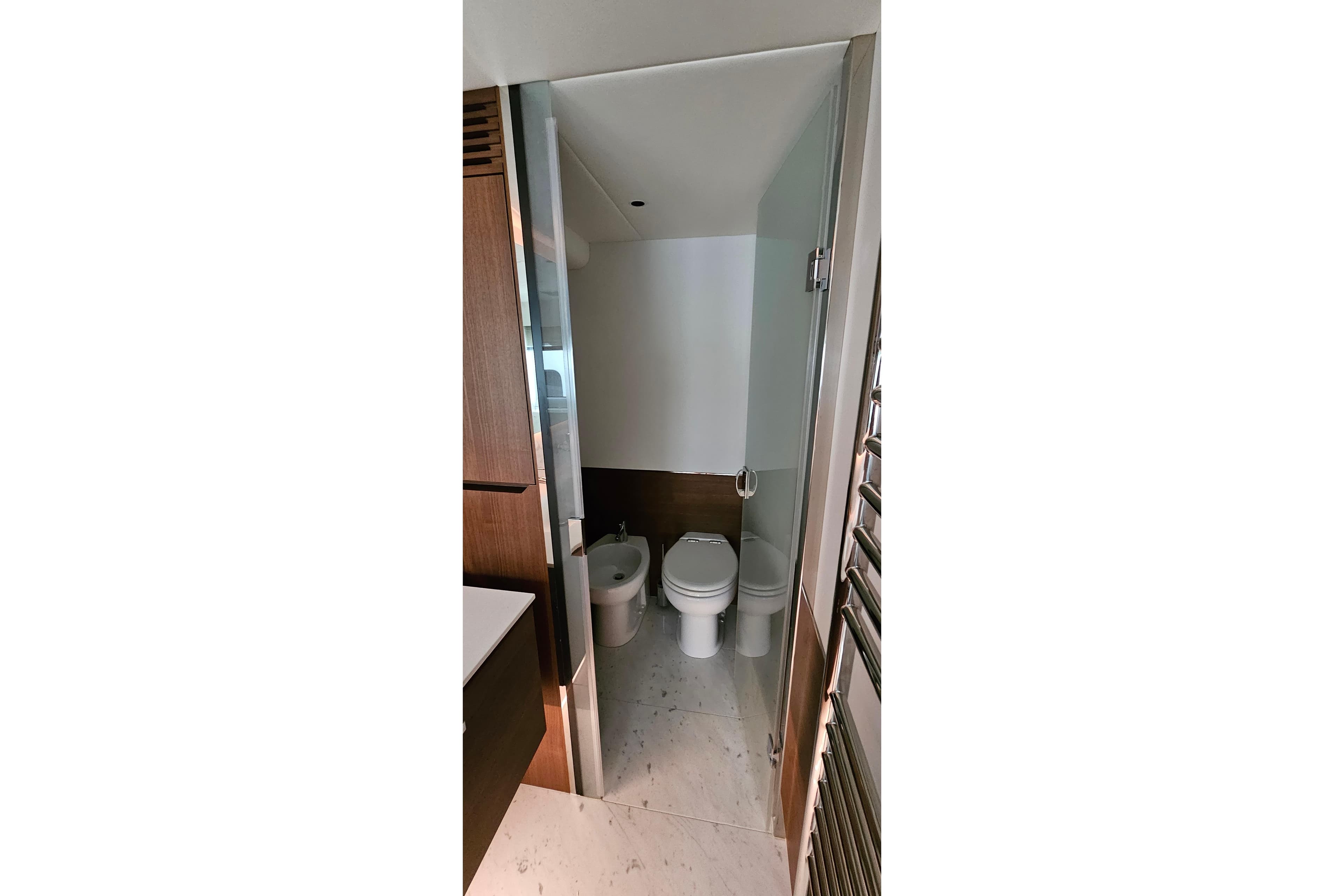 Modern bathroom in 2022 Princess Y85 yacht with toilet and bidet.