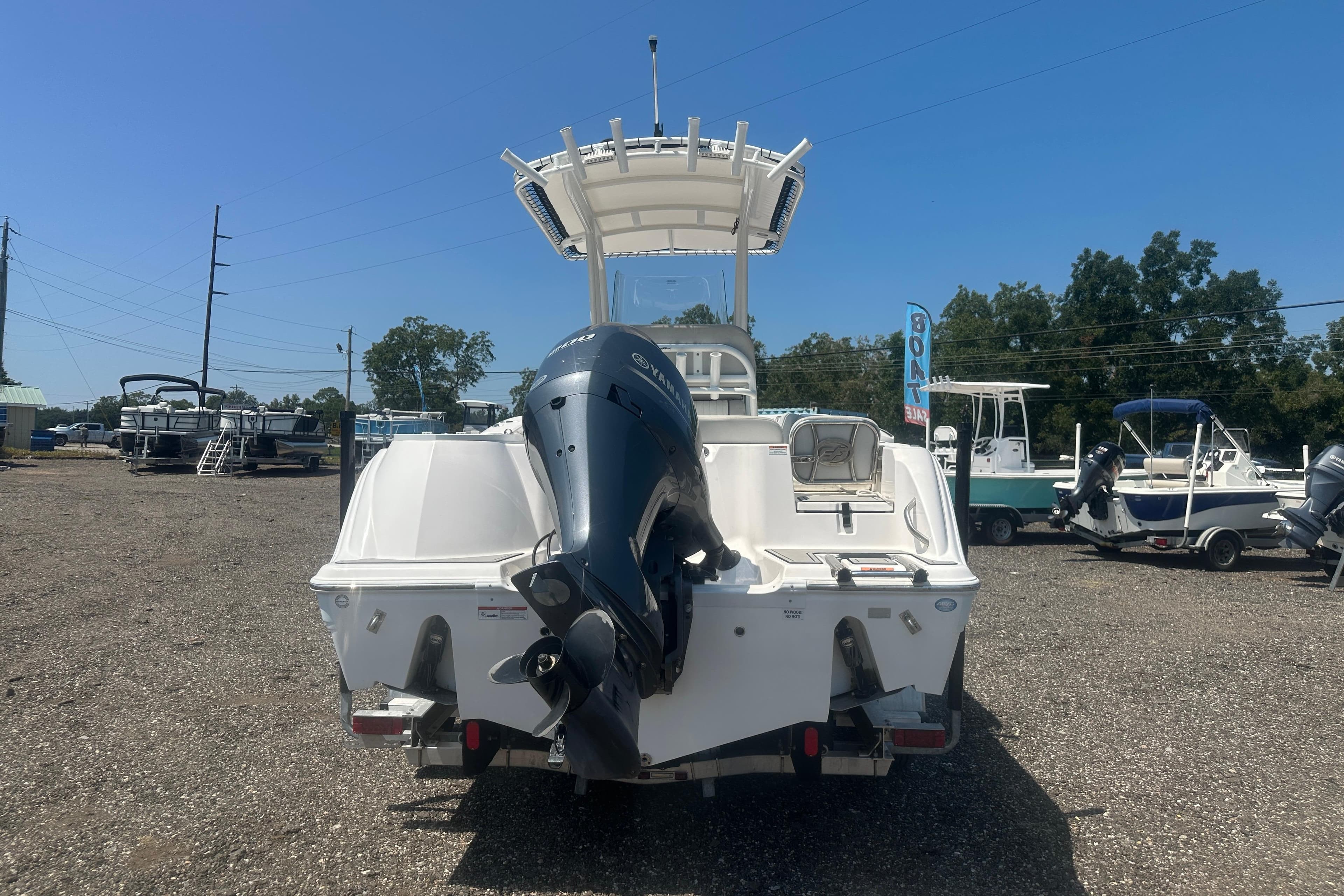 2023 Sea Fox 228 Commander boat with outboard motor, displayed outdoors.