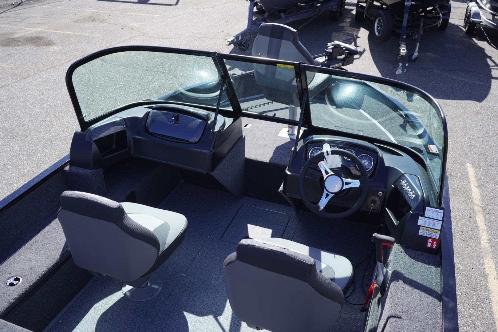 2026 Lowe Fishing Machine 1675 WT interior with dual seats and steering console.